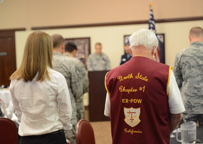 Retired U.S. Army Sgt. 1st Class Obie Wickersham (right), World War II veteran and Korean War POW, bows his head during an invocation at National POW/MIA Recognition Day event on Beale Air Force Base, California, Sept. 18, 2015. Wickersham was captive for 28 months after Chinese forces overran his platoon May 17, 1951. (U.S. Air Force photo by Chandresh Bhakta)