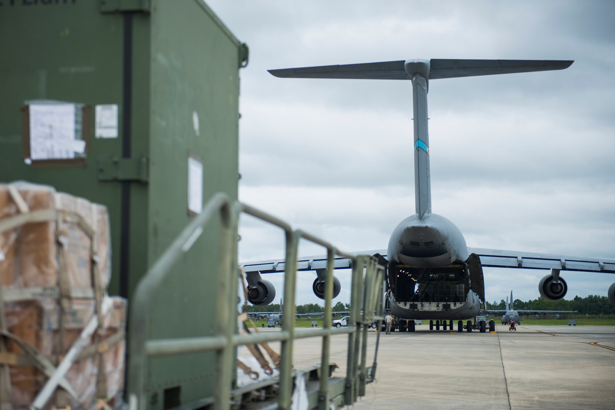 Members of Team Moody prepare to load cargo into a C-5M Super Galaxy for a deployment Sept. 16, 2015, at Moody Air Force Base, Ga. Team Moody deployed more than 300 Airmen to northwest Europe as part of Theater Security Package in support of Operation Atlantic Resolve. (U.S. Air Force photo by Airman 1st Class Dillian Bamman/Released)
