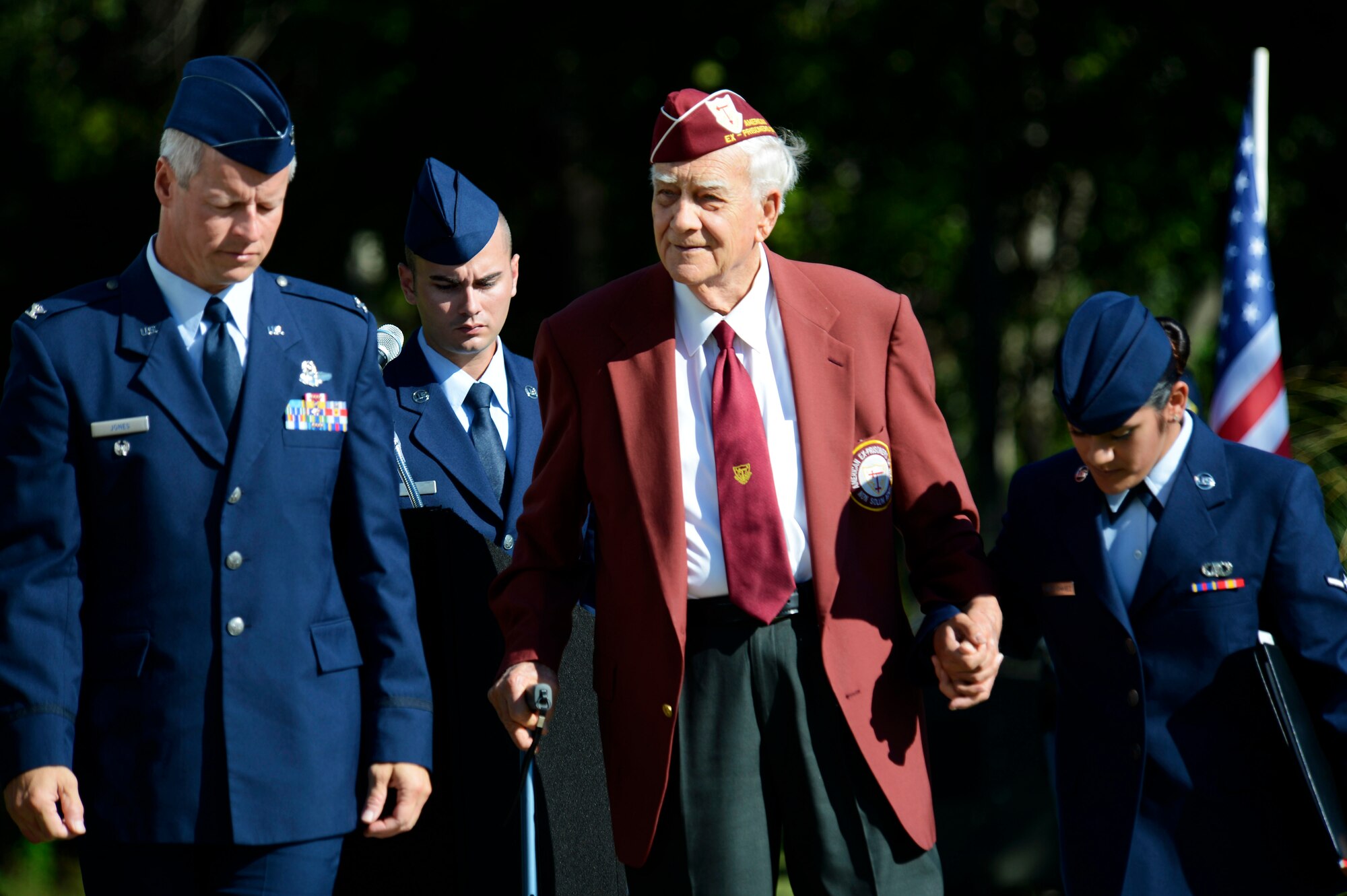 William Pebley, a former prisoner of war, is helped back to his seat by 20th Fighter Wing Airmen after giving a speech during a POW/MIA ceremony at Shaw Air Force Base, S.C., Sept. 18, 2015. After serving during WWII, Pebley went on to become the American Ex-Prisoners of War state commander and has helped more than 100 POW/MIAs and their families receive benefits. (U.S. Air Force photo by Senior Airman Jensen Stidham/Released)