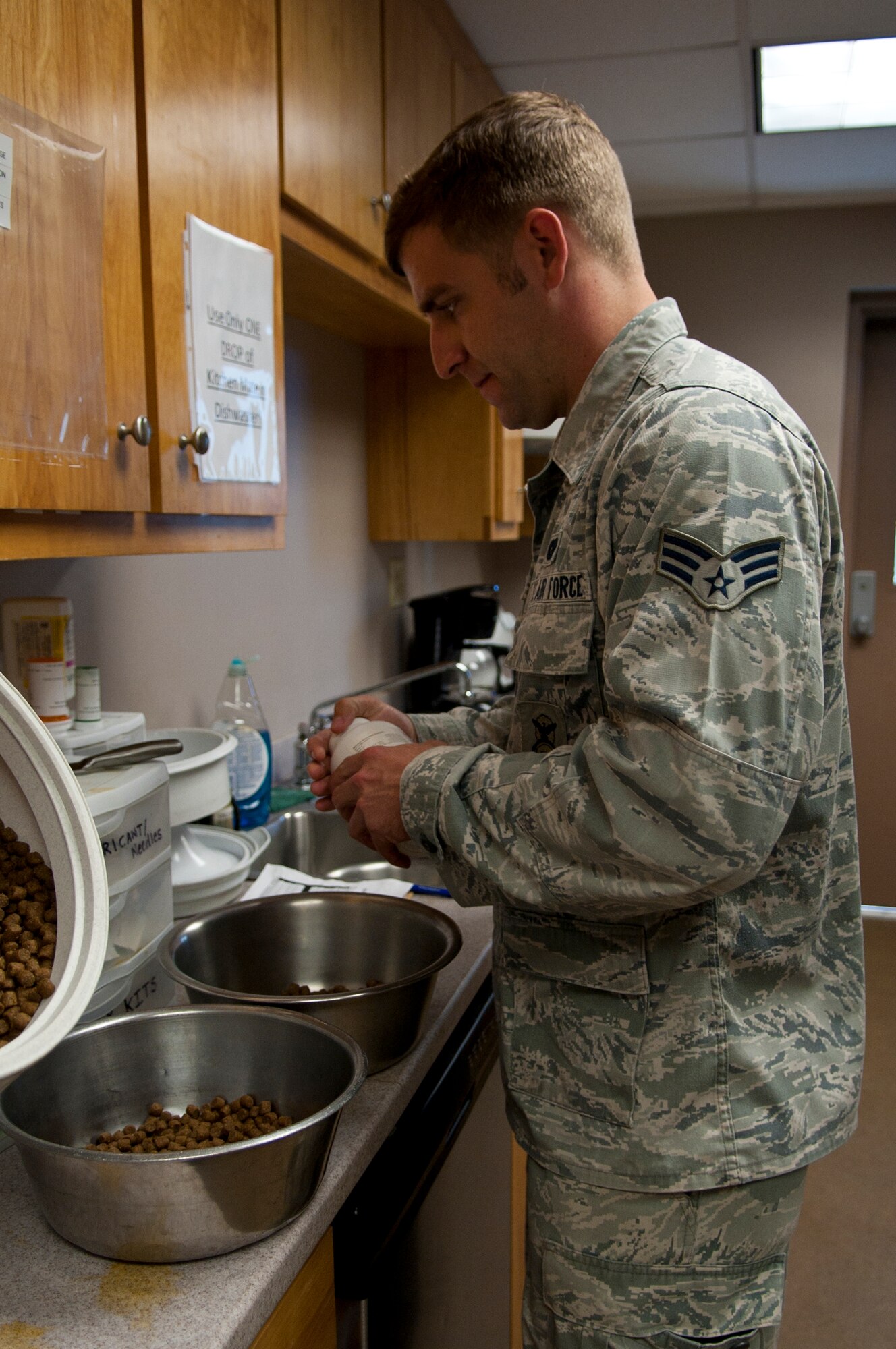 Senior Airman Austin Craven, 4th Security Forces Squadron military working dog handler, measures out dog food for two of the squadron’s MWDs, Sept. 8, 2015, at Seymour Johnson Air Force Base, North Carolina. All MWDs are on a strict eating schedule arranged by what shift they are presently working. (U.S. Air Force photo/Airman 1st Class Shawna L. Keyes)