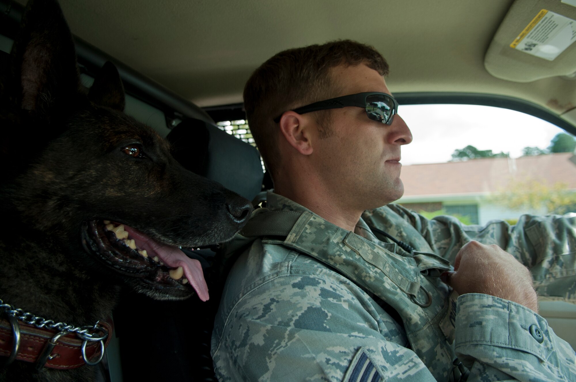 Senior Airman Austin Craven, 4th Security Forces Squadron military working dog handler, patrols the base with MWD Ronni, Sept. 8, 2015, at Seymour Johnson Air Force Base, North Carolina. Although Craven has only been at Seymour Johnson AFB since January, Ronni is a near 3-year veteran of the base. (U.S. Air Force photo/Airman 1st Class Shawna L. Keyes)   )