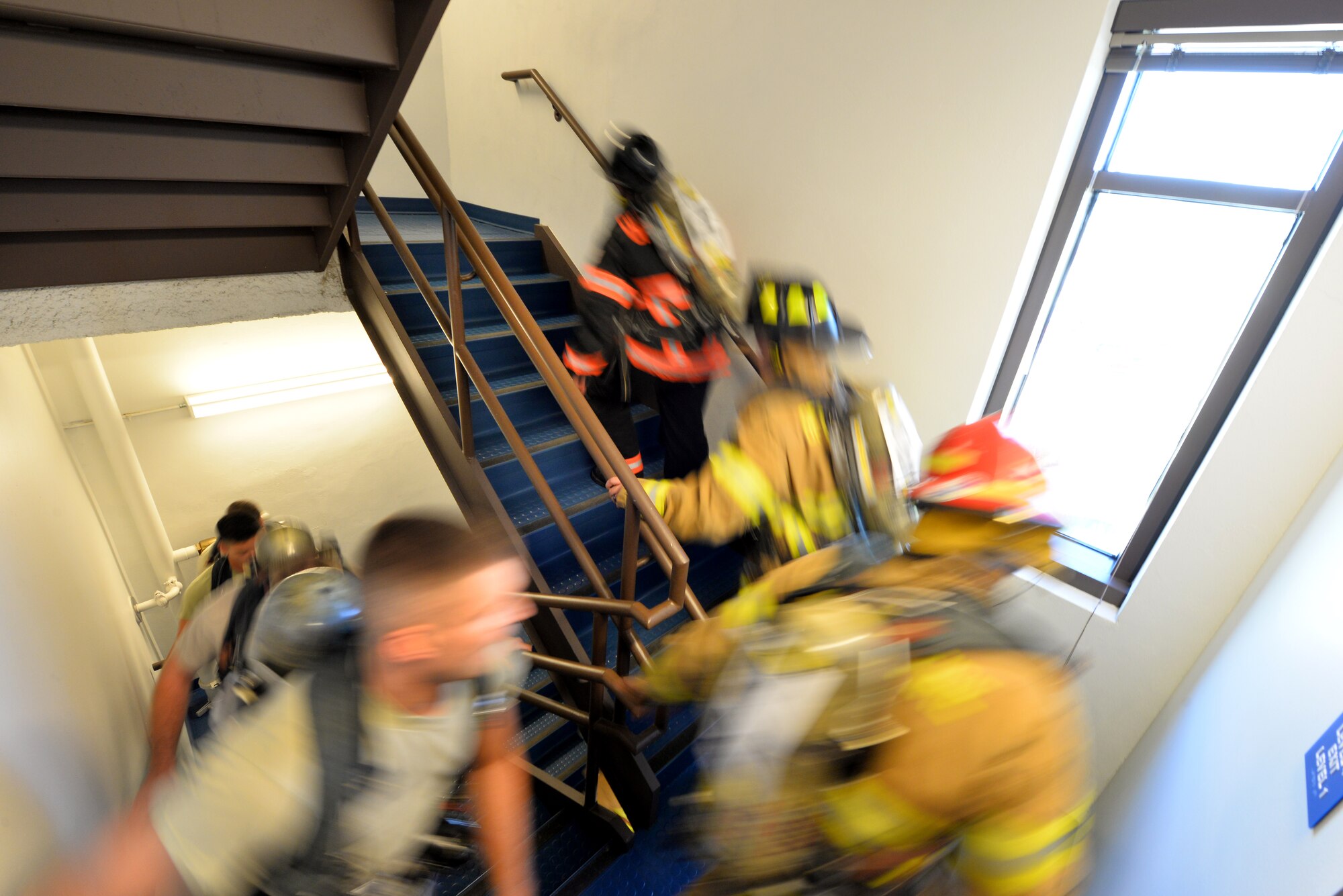 Offutt firefighters, alongside Airmen, climb stairs of the Offutt Flight Tower on Sept. 11, Offutt Air Force Base, Neb.  With photos of New York City’s fallen heroes taped to their oxygen tanks, participants scaled the tower steps over and over again until they matched the number of step in the 110 story Twin Towers. (U.S. Air Force photo by Josh Plueger/Released)