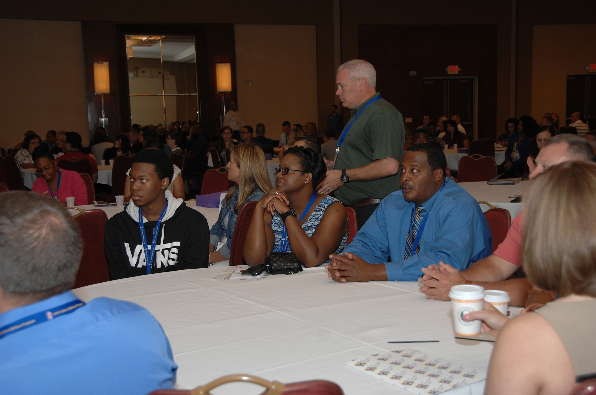 Anthony Jackson Jr. and his mother, Senior Master Sgt. Paula Jackson, participate in Air Force Reserve Yellow Ribbon Reintegration Program training Aug. 15, 2015, in Arlington, Virginia, with family friend Andre Duff. The sergeant, operations superintendent of the 700th Airlift Squadron at Dobbins Air Reserve Base, Georgia, recently returned from a four-month deployment to the 386th Expeditionary Operations Support Squadron in Southwest Asia. (U.S. Air Force photo/Senior Master Sgt. Jill LaVoie)