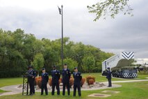 Airmen from Grand Forks Air Force Base, North Dakota, gather at the Freedom Tree Memorial Sept. 17, 2015, for a ceremony honoring POW/MIAs. The ceremony hosted by the 319th Air Base Wing was put together by the Air Force Sergeant's Association Chapter 964. (U.S. Air Force photo by Senior Airman Desiree Economides/Released)