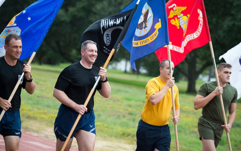 (Left to right) Col. John Lamontagne, 437th Airlift Wing commander, Col. Robert Lyman, Joint Base Charleston commander, GM1 Joseph Blacka and Lance Cpl. John Meert participate in the 24 hour POW/MIA Vigil Run Sept. 18, 2015, at the Air Base track on JB Charleston, S.C. National POW/MIA Recognition day is traditionally observed on the third Friday in September each year. The Vigil Run is to honor our country’s prisoners of war and those missing in action. (U.S. Air Force photo/Airman 1st Class Clayton Cupit)