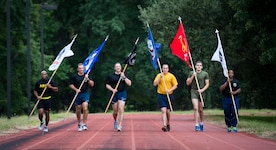 (Left to right) Lt. Col. Dennis Major, 841st Transportation Battalion commander, Col. John Lamontagne, 437th Airlift Wing commander, Col. Robert Lyman, Joint Base Charleston commander, GM1 Joseph Blacka, Lance Cpl. John Meert and Staff Sgt. Gregory Hamlin, 628th Comptroller Squadron participate in the 24 hour POW/MIA Vigil Run Sept. 18, 2015, at the Air Base track on JB Charleston, S.C. National POW/MIA Recognition day is traditionally observed on the third Friday in September each year. The Vigil Run is to honor our country’s prisoners of war and those missing in action. (U.S. Air Force photo/Airman 1st Class Clayton Cupit) 

