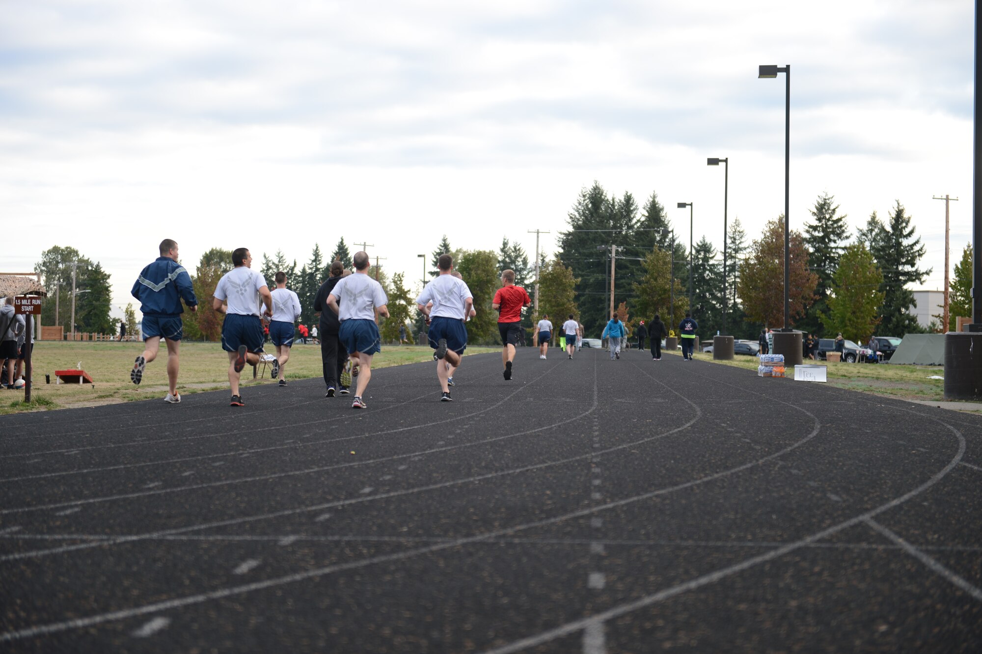 McChord Airmen sprint through the last portion of their run during the 24-hour POW/MIA Memorial run, as part of the 2015 POW/MIA Remembrance Week, at the McChord Field outdoor track, Joint Base Lewis-McChord, Wash., Sept. 16, 2015. Between the participating teams, a total of 5286 miles were completed during the 24 hour POW/MIA Memorial Run. (U.S. Air Force photo/Staff Sgt. Katie Jackson) 