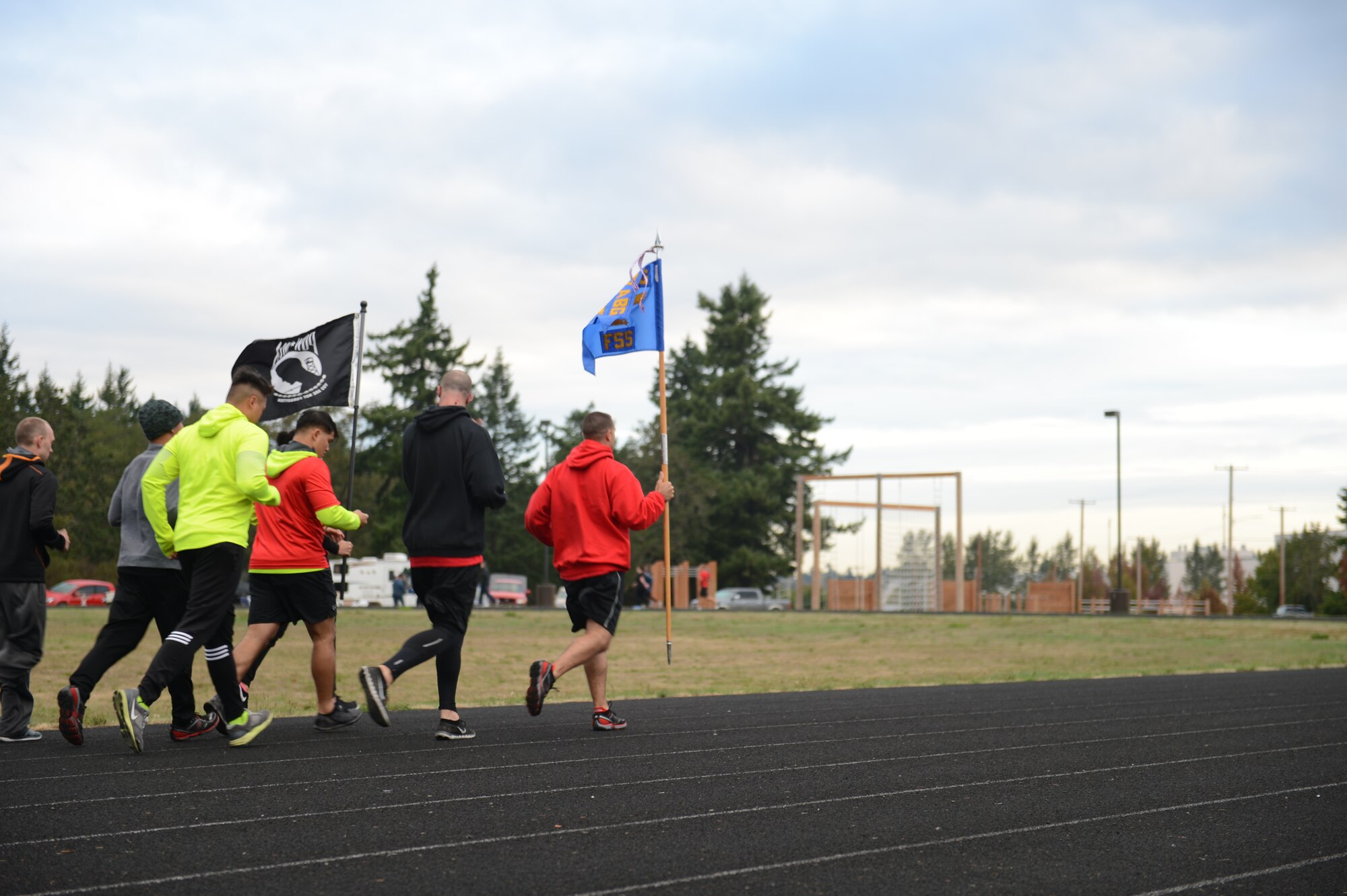 Airmen from the 627th Force Support Squadron complete the last portion of the 24-hour POW/MIA Memorial run, part of the 2015 POW/MIA Remembrance Week, at the McChord Field outdoor track, Joint Base Lewis-McChord, Wash., Sept. 16, 2015. The Sled Dogs team was the top fundraisers raising more than $180 and team Chaos completed the highest mileage at 286.75 miles. (U.S. Air Force photo/Staff Sgt. Katie Jackson)
