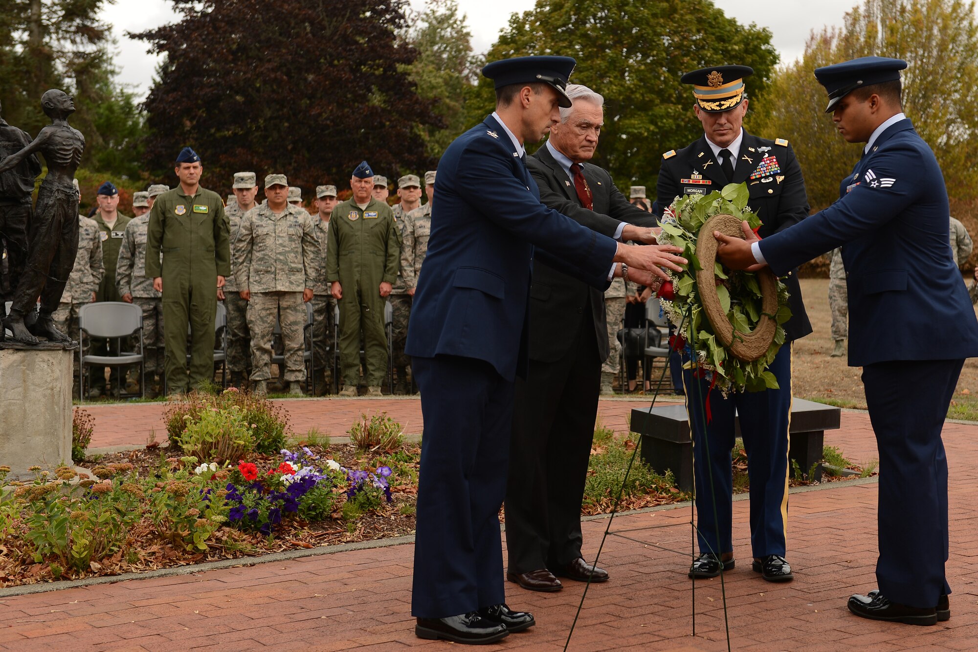 Col. Leonard Kosinski (left to right), 62nd Airlift Wing commander, retired Lt. Col. Barry Bridger, former prisoner of war, Col. Dan Morgan, Joint Base Lewis-McChord installation commander, place a wreath at Memorial Park at McChord Field, Wash Sept. 16, 2015. POW/MIA week included several events in addition to the wreath laying, to include a 24-hour run, a motorcycle ride, and a luncheon. (U.S Air Force photo/Staff Sgt. Tim Chacon)
