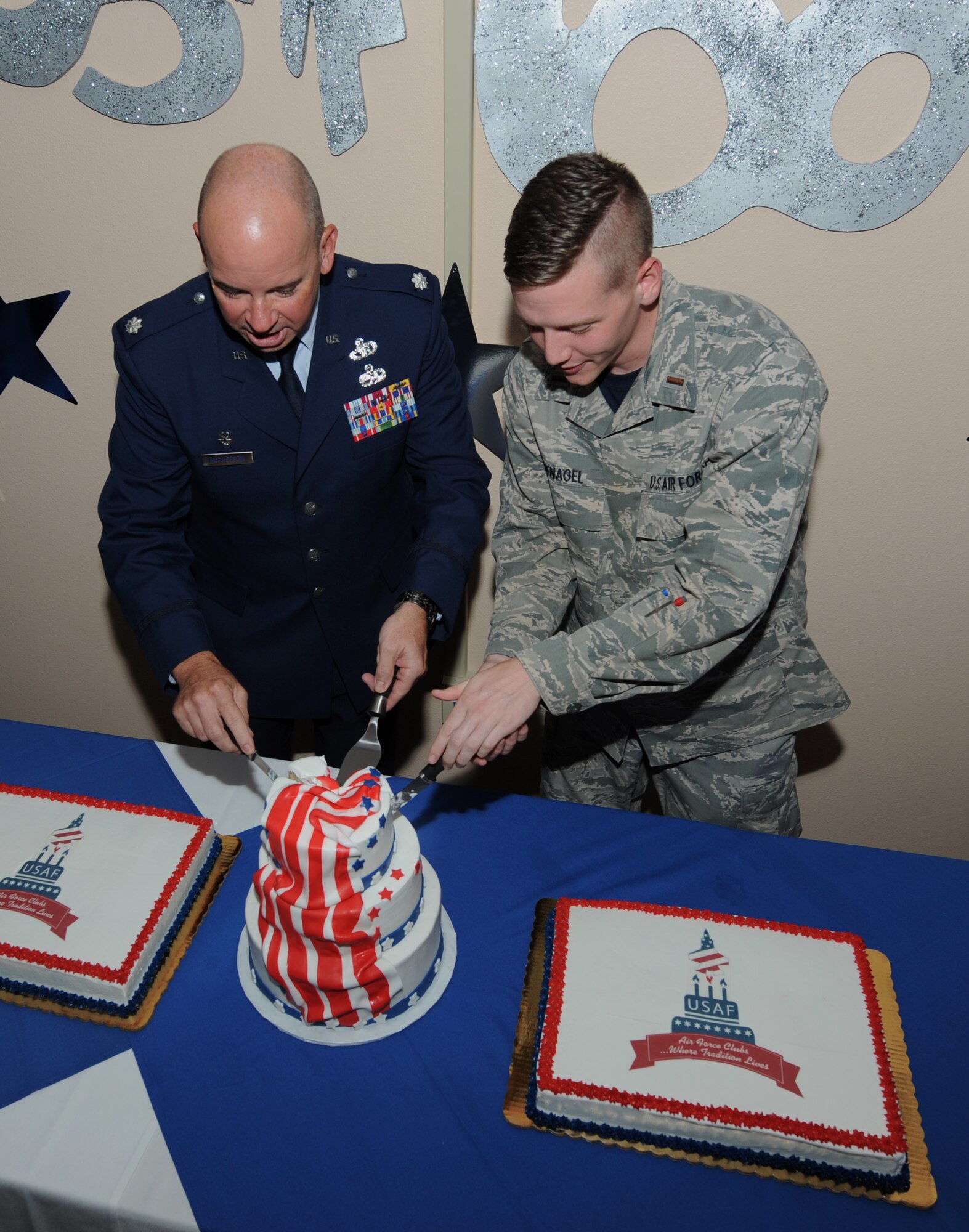 U.S. Air Force Lt. Col. Ray McPherson, 7th Logistical Readiness Squadron commander, and 2nd Lt. Nicholas Hufnagel, 7th Equipment Maintenance Squadron, cut a cake together Sept. 18, 2015, at Dyess Air Force Base, Texas. As part of an Air Force tradition, the oldest and youngest Airmen on a base are the first to cut the Air Force birthday cake. (U.S. Air Force photo by Airman 1st Class Austin Mayfield/Released)