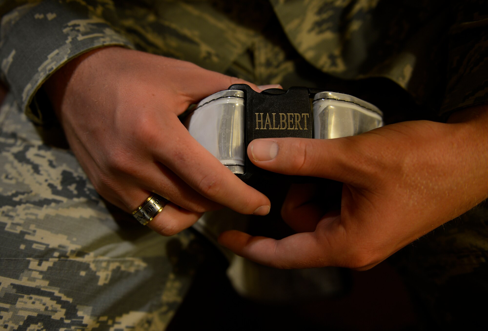 Airman 1st Class Britton Halbert, 703rd Aircraft Maintenance Squadron aerospace maintenance apprentice, removes his reflective belt after his work day on the flight line is over. Halbert is responsible for maintaining aircraft and inspecting the aircraft before and after a plane lands to make sure it's in operation-ready condition. (U.S. Air Force photo/Airman Valerie Monroy)