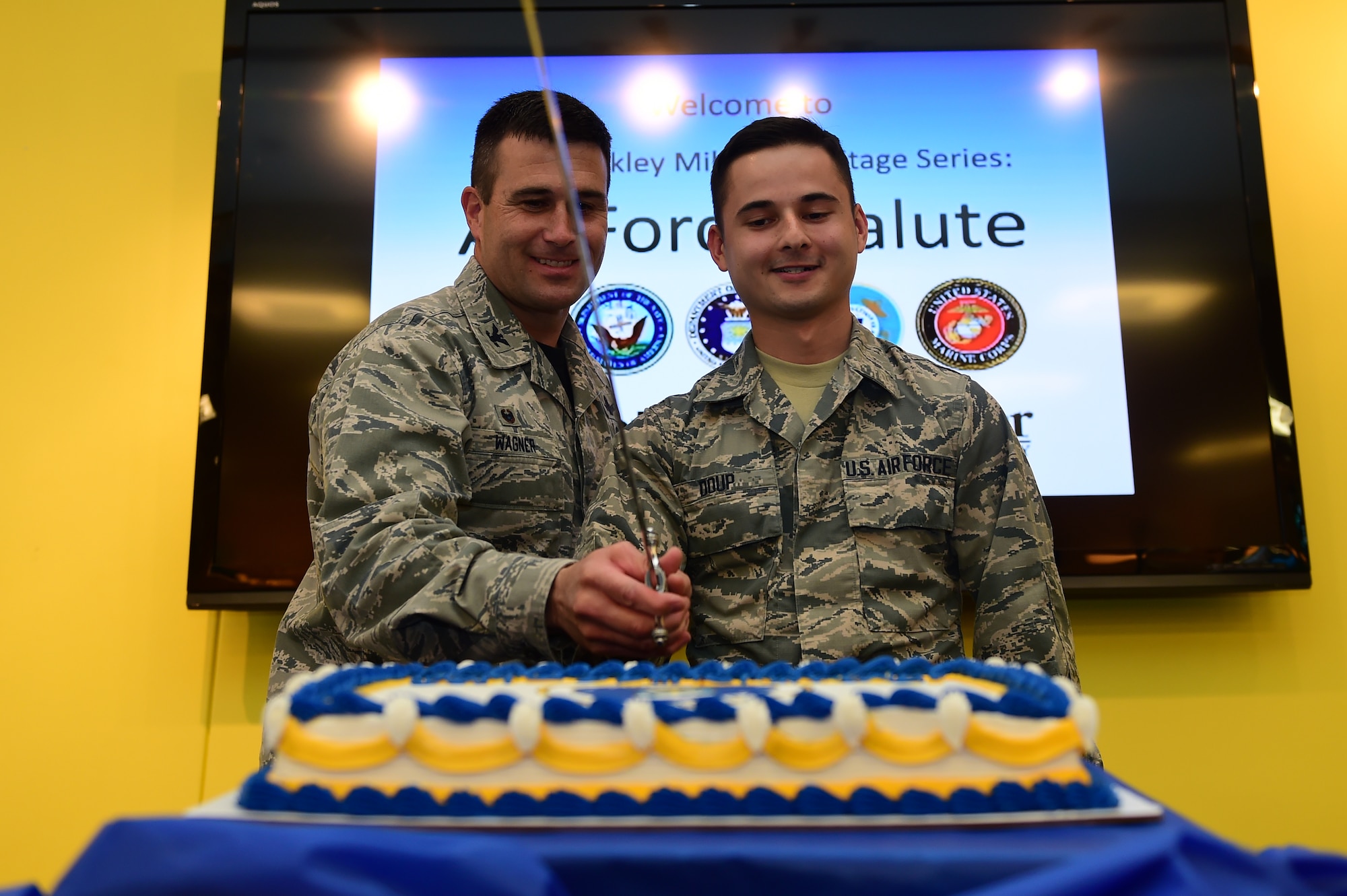 Col. John Wagner, 460th Space Wing commander, and Airman Anthony Doup, 460th Space Communications Squadron, cut the Air Force birthday cake Sept. 18, 2015, on Buckley Air Force Base. The Air Force turns 68 this year and continues to fly, fight and win in air, space and cyberspace. (U.S. Air Force photo by Airman 1st Class Luke W. Nowakowski/Released)