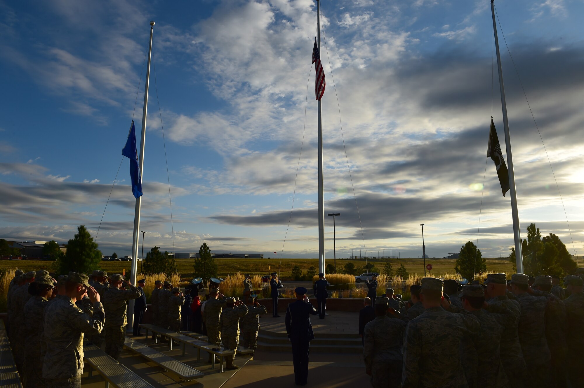The Prisoner of War/Missing in Action flag was raised in the place of the American flag during a ceremony Sept. 18, 2015, on Buckley Air Force Base, Colo. The ceremony recognized those who have had to endure enemy captivity and those who never made it back home after a conflict. The guest of honor retired Tech. Sgt. Jasper Page, was a POW during the Vietnam War but escaped captivity and was able to make it back to American positions safely. (U.S. Air Force photo by Airman 1st Class Luke W. Nowakowski/Released)