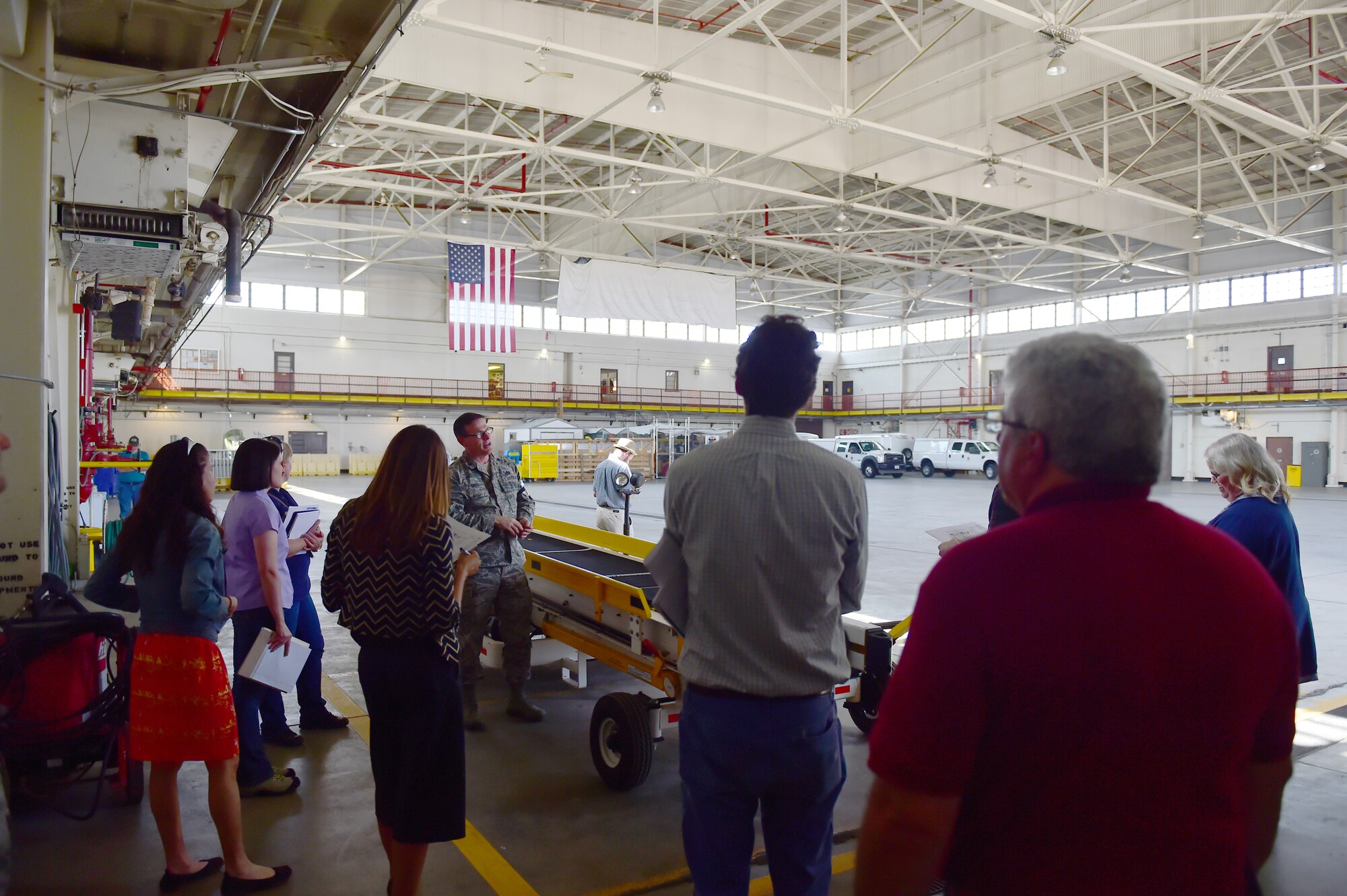 Lt. Col. William Smith, 140th Civil Engineer Squadron base civil engineer, leads preservationists on a tour of Hangar 909 Sept. 14, 2015, on Buckley Air Force Base, Colo. Hangar 909 is being refurbished due to its deteriorating infrastructure. The project is set to begin in September 2016 and will not only improve the hangar’s structural integrity, and also enhance it to be able to support F-16 Fighting Falcon simulators for training purposes. (U.S. Air Force photo by Airman 1st Class Luke W. Nowakowski/Released)