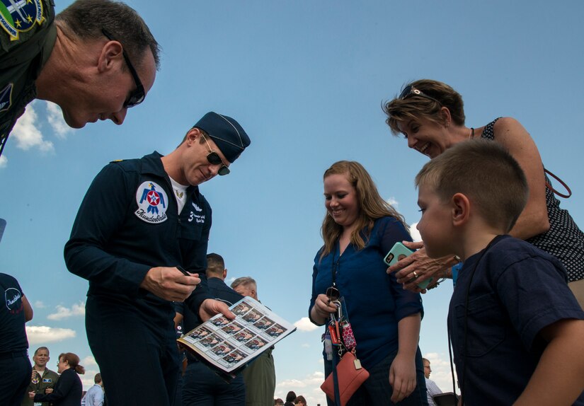 Maj. Alexander Goldfein, U.S. Air Force Thunderbird pilot, signs an autograph for a Make a Wish recipient during an air show rehearsal on Joint Base Andrews, Md., Sept. 18, 2015. The U.S. Air Force holds air shows to inspire patriotism and demonstrate air superiority to the local community. (U.S Air Force photo by Airman 1st Class Philip Bryant/Released)