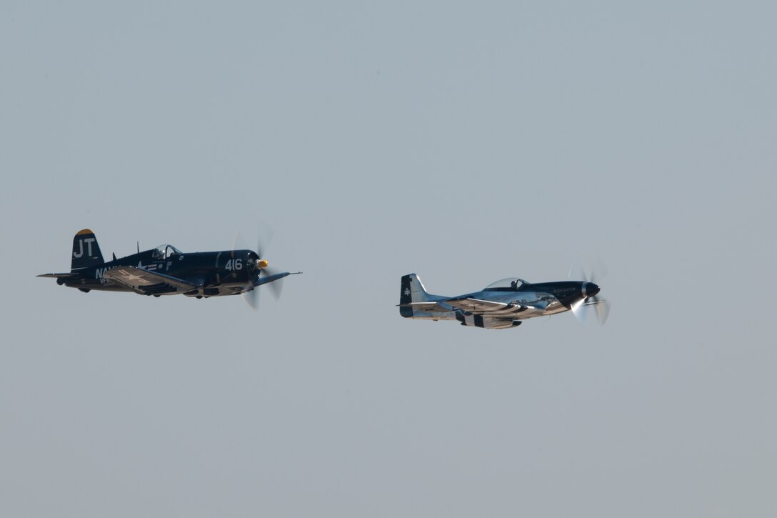 A P-40 Warhawk and P-51 Mustang perform during an air show rehearsal Sept. 18, 2015 at Joint Base Andrews, Md. The P-40 and P-51 will participate in the 2015 JBA Air Show, Sept. 19, 2015. (U.S. Air Force photo by Senior Airman Dylan Nuckolls/Released)