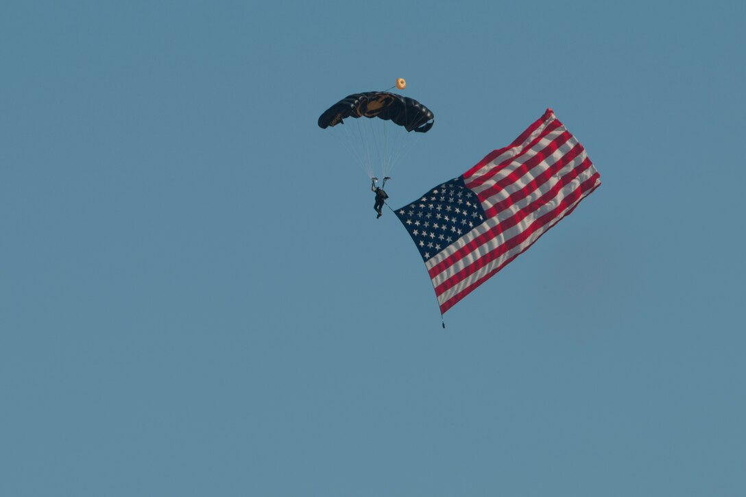 A member of the U.S. Special Operations Command Parachute Team parachutes during an air show rehearsal Sept. 18, 2015 at Joint Base Andrews, Md. The SOC Parachute Team will participate in the 2015 JBA Air Show, Sept. 19, 2015. (U.S. Air Force photo by Senior Airman Dylan Nuckolls/Released)