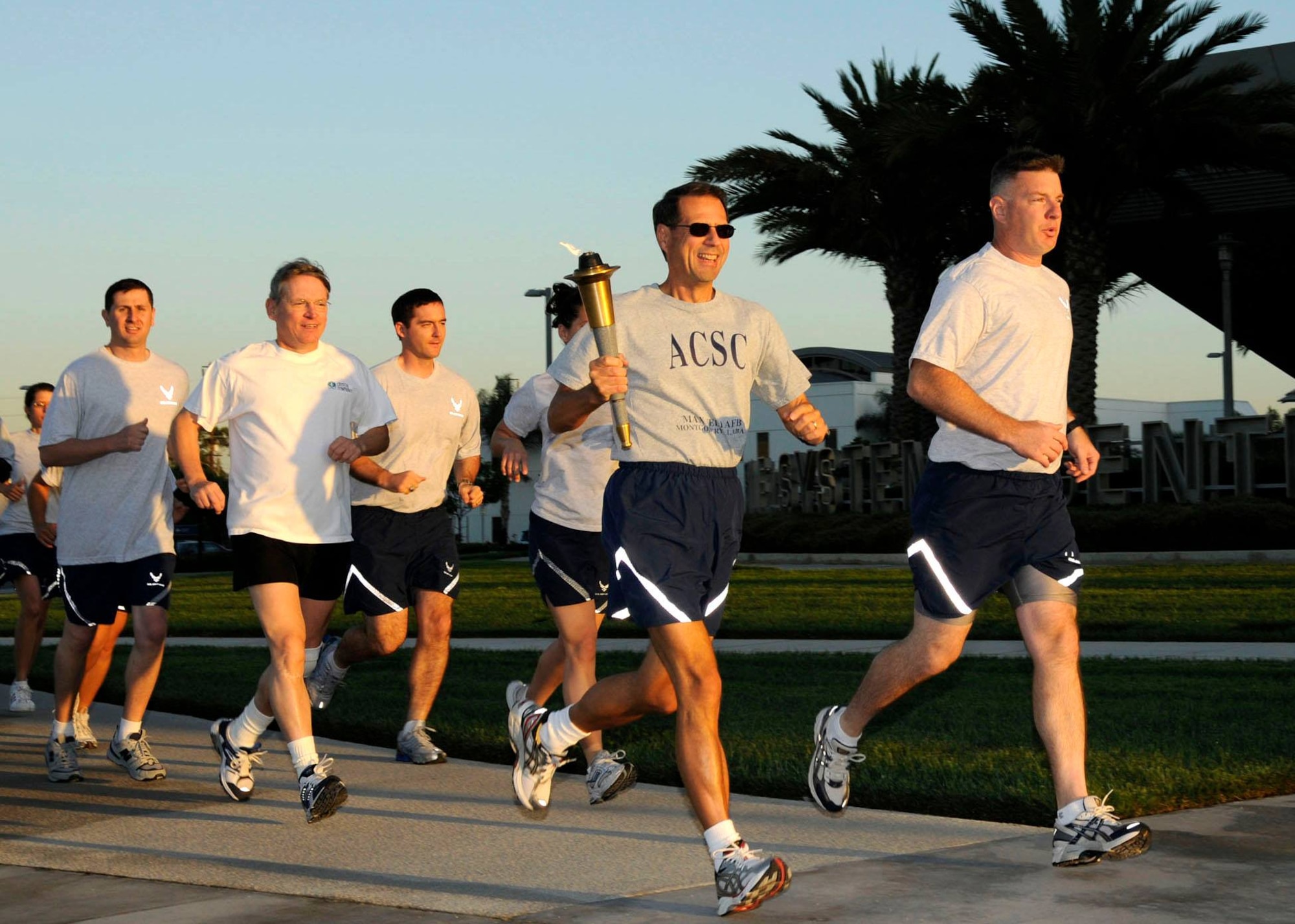 As the sun sets in the West with 54 miles behind them, the POW/MIA torch relay team arrives on the grounds of the Space and Missile Systems Center's Schriever Space Complex at Los Angeles Air Force Base in El Segundo, Calif. Another 100 miles will be pounded out overnight on the running track as each runner executed the same mission – ensuring the torch remained lit to represent the nation’s resolve; moving it ever forward to show the promise to those missing warriors and their families. (Courtesy photo/James R. Gill)