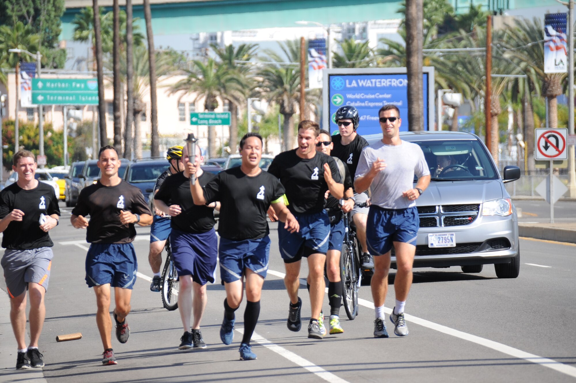 A team of runners from the Space and Missile Systems Center at Los Angeles Air Force Base in El Segundo, Calif. carry the POW/MIA torch on the start of a 24-hour, 154 mile long course through the South Bay beach communities of Los Angeles to honor those who were held captive – and those still missing and unaccounted for during times of armed conflict. (U.S. Air Force photo/Van Ha)