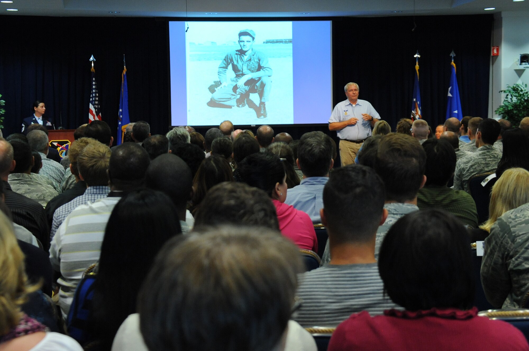 With an image of his father, Medal of Honor recipient Chief Master Sgt. Richard Etchberger in the background, Mr. Cory Etchberger reflects on the sacrifice of people who have made U.S. Air Force what it is today during a celebration of the Air Force’s 68th Birthday Sept. 18 in the Schriever Space Complex's Gordon Conference Center at Los Angeles Air Force Base in El Segundo, Calif. (U.S. Air Force photo/Van De Ha)