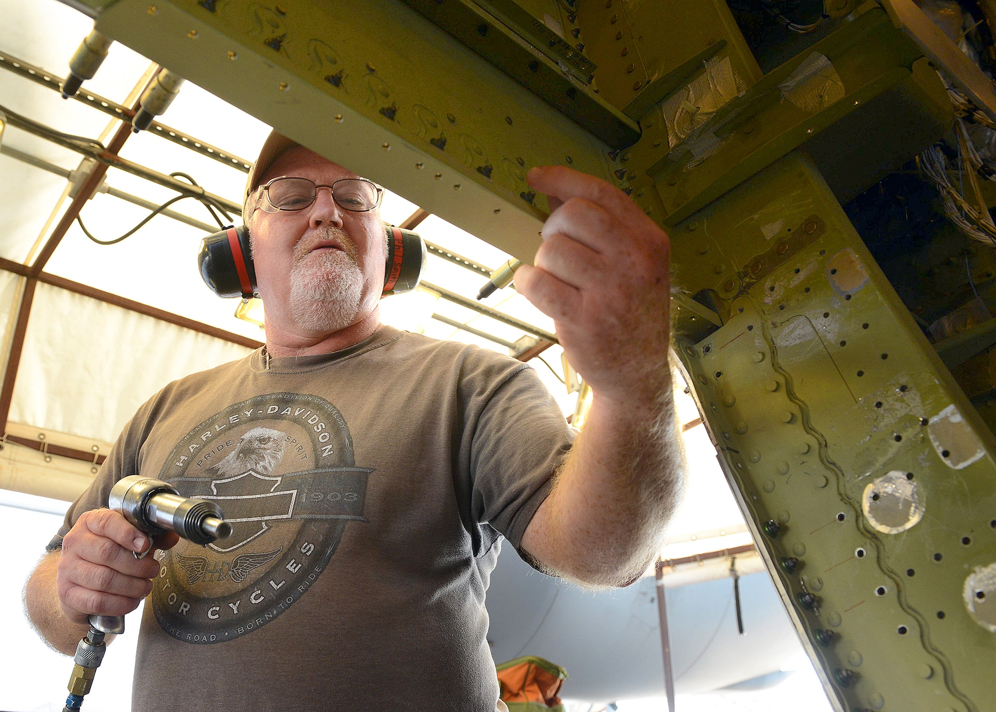 Phillip Smith, 559th Aircraft Maintenance Group sheet metal mechanic, works on a C-17 Globemaster III at Warner Robins Air Logistics Complex. The last of 76 of these aircraft modified with a missile threat detection and countermeasures system at Robins departed Sept. 11. The program was the result of two squadrons – the 559th and 562nd Aircraft Maintenance Squadrons - collaborating to form a relationship that has not only reduced cost and improved quality on the line, but also resulted in a 93 percent on-time delivery rate to its customers over that time period. (U.S. air Force photo by Tommie Horton)