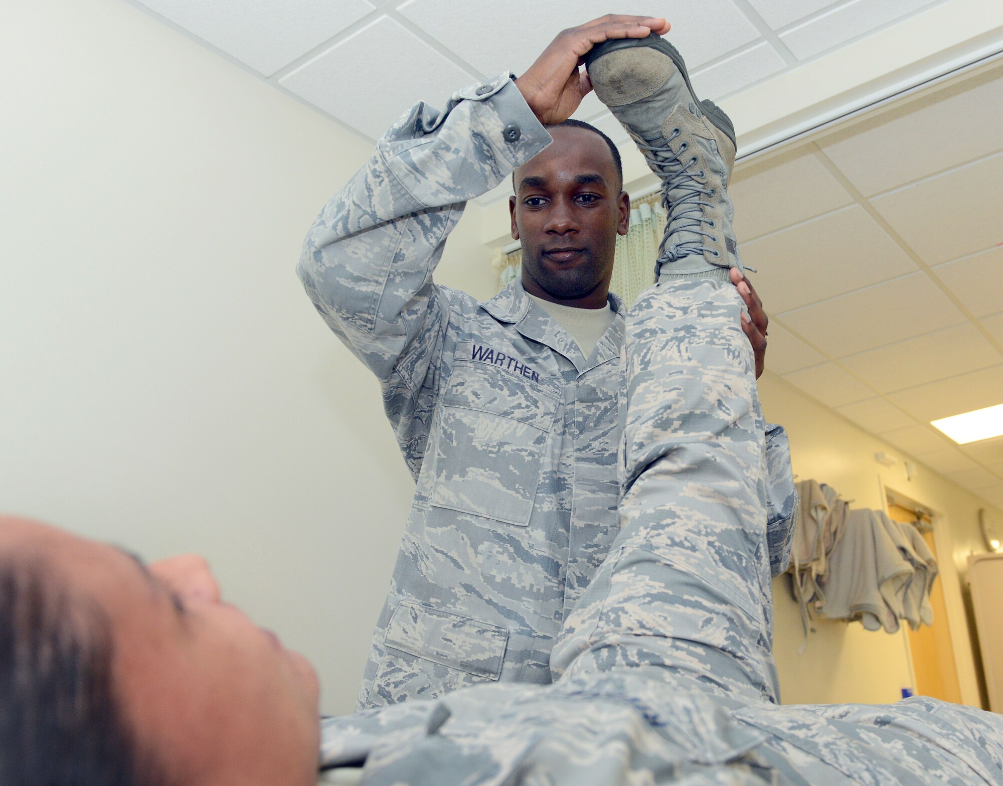 Staff Sgt. Javaris Warthen, 78th Medical Group physical therapy craftsman conducts manual physical therapy with Master Sgt. Jessica Rivera. (U.S. Air Force photo by Tommie Horton)