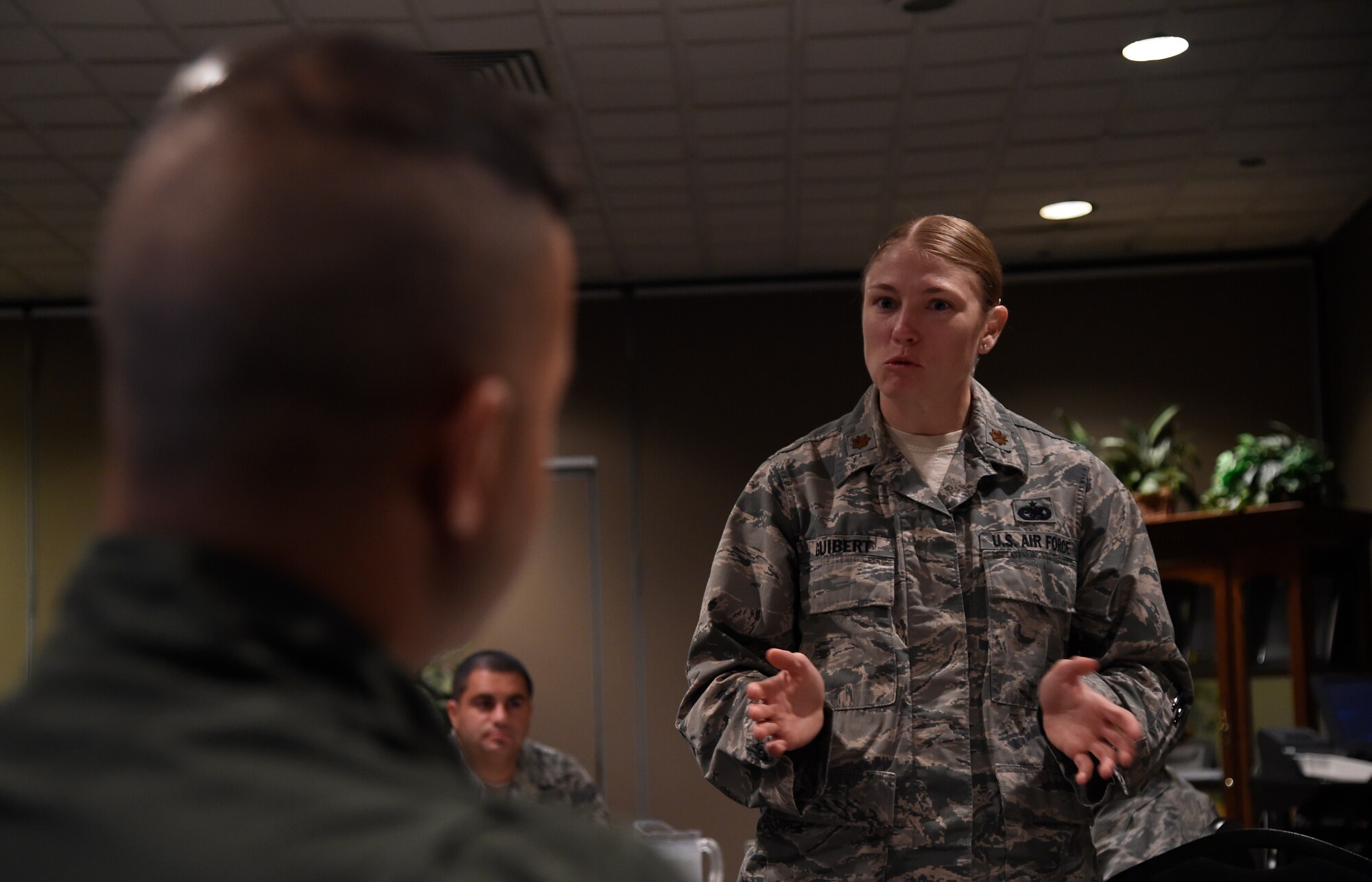 Maj. Lauren Guibert, 818th Mobility Support Advisory Squadron air advisor, speaks to two Tunisian Airmen during their breakfast orientation at Joint Base McGuire-Dix-Lakehurst, N.J., Sept. 16, 2015. The weeklong engagement focused on sharing ideas and experiences in the realm of airbase defense. (U.S. Air Force photo by Staff Sgt. Gustavo Gonzalez)