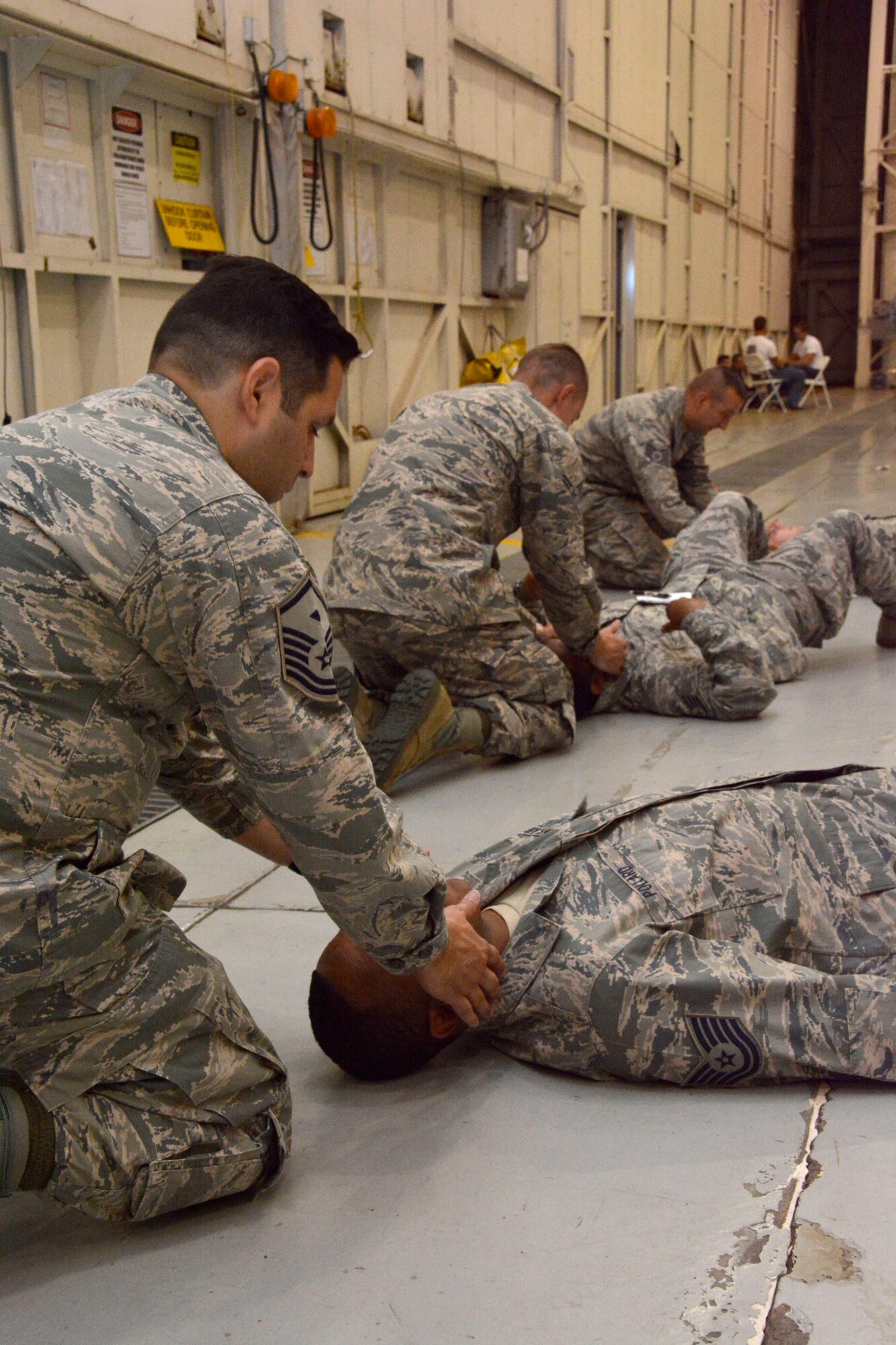 Members of the North Carolina Air National Guard, work together at one of eight stations set up for training during the Air Expeditionary Skills Rodeo, held Sept. 13, 2015, in a hangar at the North Carolina Air National Guard Base, Charlotte Douglas International Airport. These Airmen learned basic self-aid and buddy care tactics such as detection of breathing and treatment for shock during the training. (U.S. Air National Guard photo by Senior Airman Laura Montgomery, 145th Public Affairs/Released)