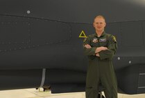 1st Lt. Brian Peterson, 348th Reconnaissance Squadron, stands in front of a RQ-4 Globalhawk at Grand Forks Air Force Base, North Dakota, Sept. 8, 2014. Peterson was nominated by his command to be the Warrior of the Week for the second week of September. (U.S. Air Force photo by Senior Airman Desiree Economides/Released)