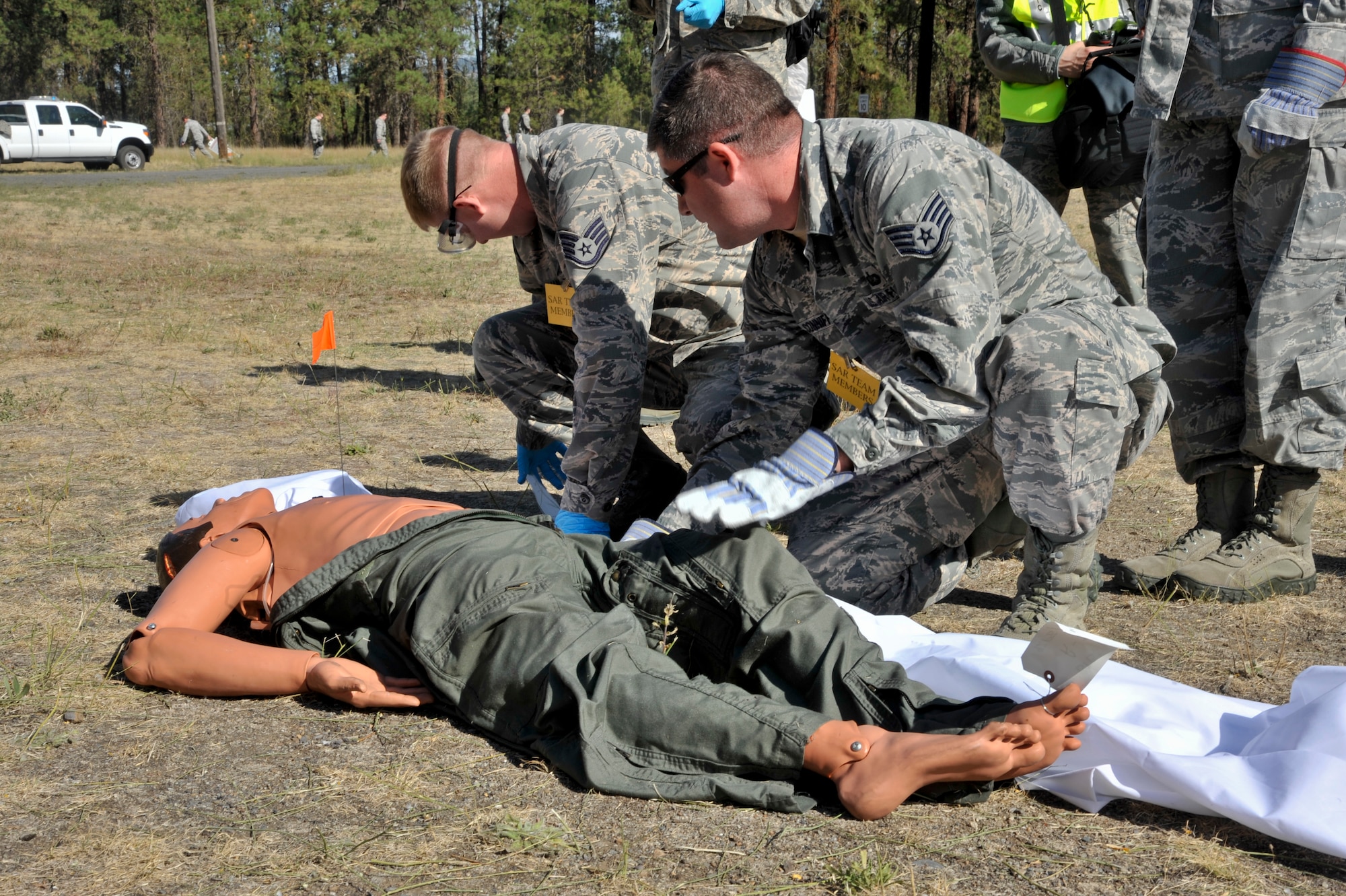 Staff Sgt. Austin Coleman and Staff Sgt. Robert Conniff, 92nd Force Support Squadron search and recovery team, demonstrate how to recover a body during a Major Accident Response Exercise Sept. 16, 2015 at Riverside State Park in Spokane, Wash. The SAR team practiced what they would do in a real search and recovery mission during the MARE that involved a mock crash of a KC-135 Stratotanker. (U.S. Air Force photo/Airman 1st Class Taylor Bourgeous)