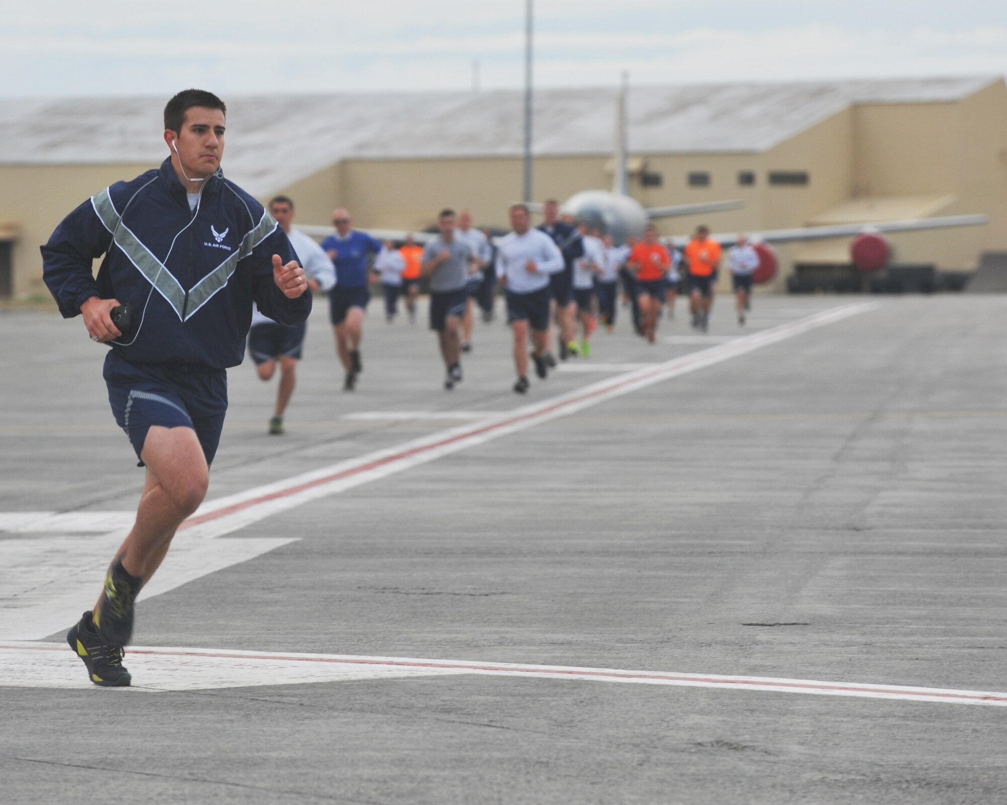 Members of Team Fairchild run on the flightline during a prisoner of war/missing in action wing run hosted by the 92nd Maintenance Group, Sept. 18, 2015 at Fairchild Air Force Base, Wash. Wing runs enhance unit cohesion through a shared experience.  (U.S. Air Force photo/Staff Sgt. Samantha Krolikowski)