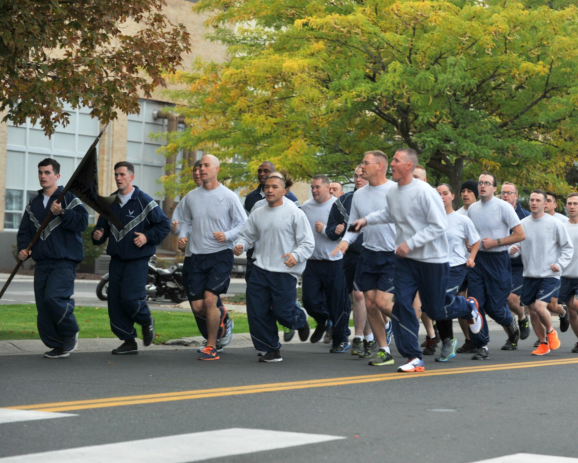 Members of the 92nd Security Forces Squadron run in formation during a prisoner of war/ missing in action wing run Sept. 18, 2015 at Fairchild Air Force Base, Wash. The run was hosted by the 92nd Maintenance Group and covered 1.55 miles around the flightline, starting and ending in front of the maintenance hangars. (U.S. Air Force photo/Staff Sgt. Samantha Krolikowski)