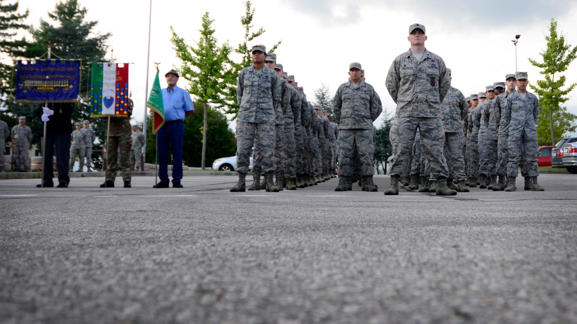 Team Aviano members stand in formation during a retreat ceremony Prisoner of War/Missing in Action Remembrance Week Sept. 17, 2015, at Aviano Air Base, Italy. According to the Defense POW/MIA Accounting Agency, there are still 83,114 service members, since World War II, who are unaccounted for. (U.S. Air Force photo by Senior Airman Areca T. Bell/Released)