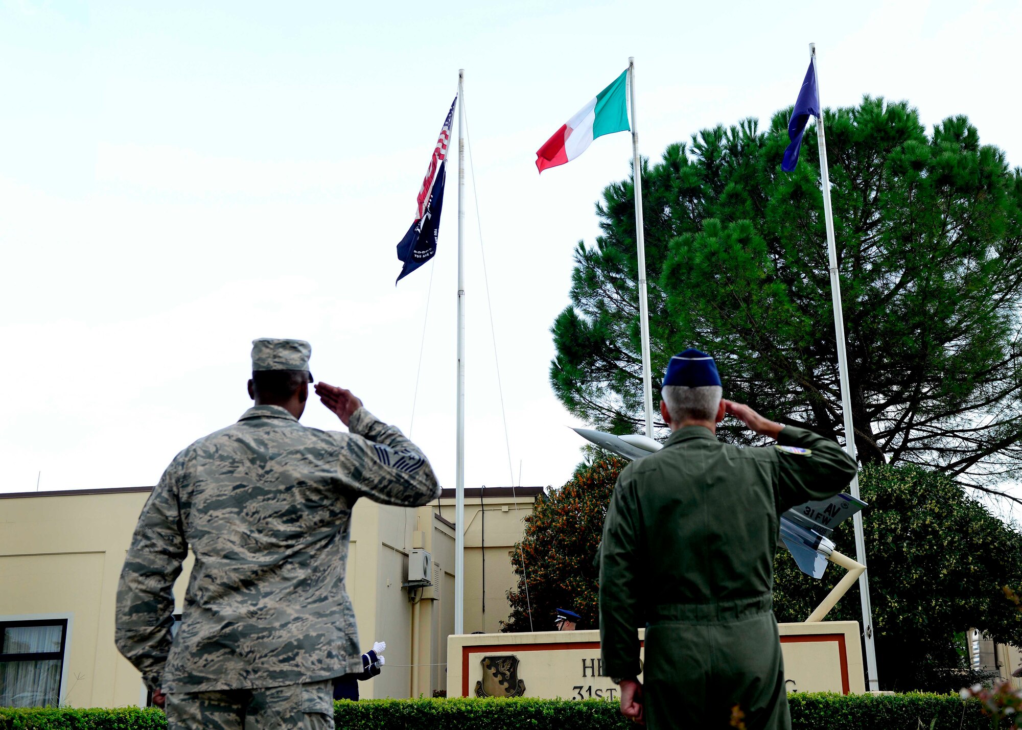 U.S. Air Force Chief Master Sgt. Anthony W. Johnson, 31st Fighter Wing command chief, and Brig. Gen. Barre R. Seguin, 31st FW commander, salute  the Italian, U.S. and Prisoner of War/Missing in Action flags during the POW/MIA Remembrance Week retreat ceremony, Sept. 17, 2015, at Aviano Air Base, Italy. According to the Defense POW/MIA Accounting Agency, there are still 83,114 service members, since World War II, who are unaccounted for. (U.S. Air Force photo by Senior Airman Areca T. Bell/Released)