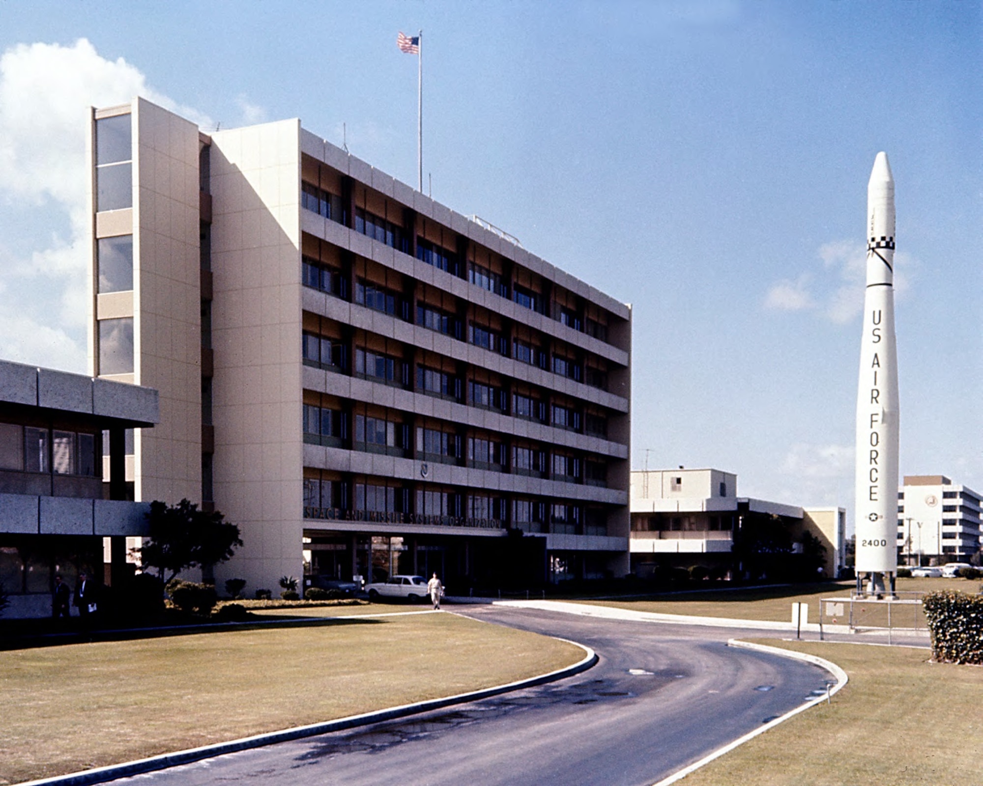 The Thor-Agena monument stands in front of Bldg. 105, headquarters of Space Systems Division in Area A of Los Angeles Air Force Station in February 1967. (U.S. Air Force photo)