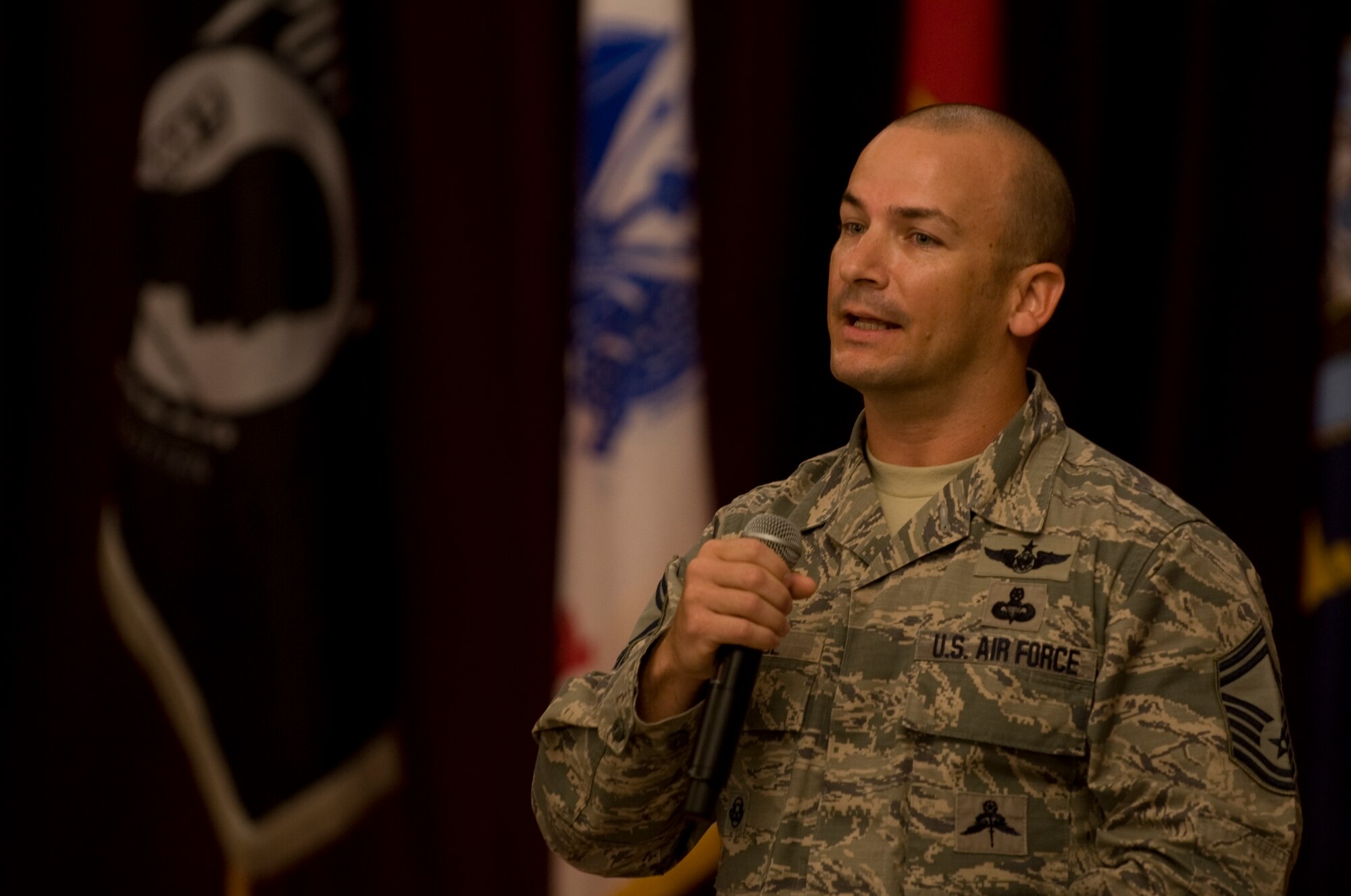 Senior Master Sgt. Caleb Ethridge, 31st Rescue Squadron superintendent, delivers a speech about his experiences as a personnel rescue specialist during a Prisoner of War/Missing in Action breakfast at the Kadena Officer’s Club Sept. 18, 2015, Kadena Air Base, Japan. The breakfast served as a way to honor those killed in action and missing. (US Air Force photo by Airman 1st Class Nicholas Emerick)