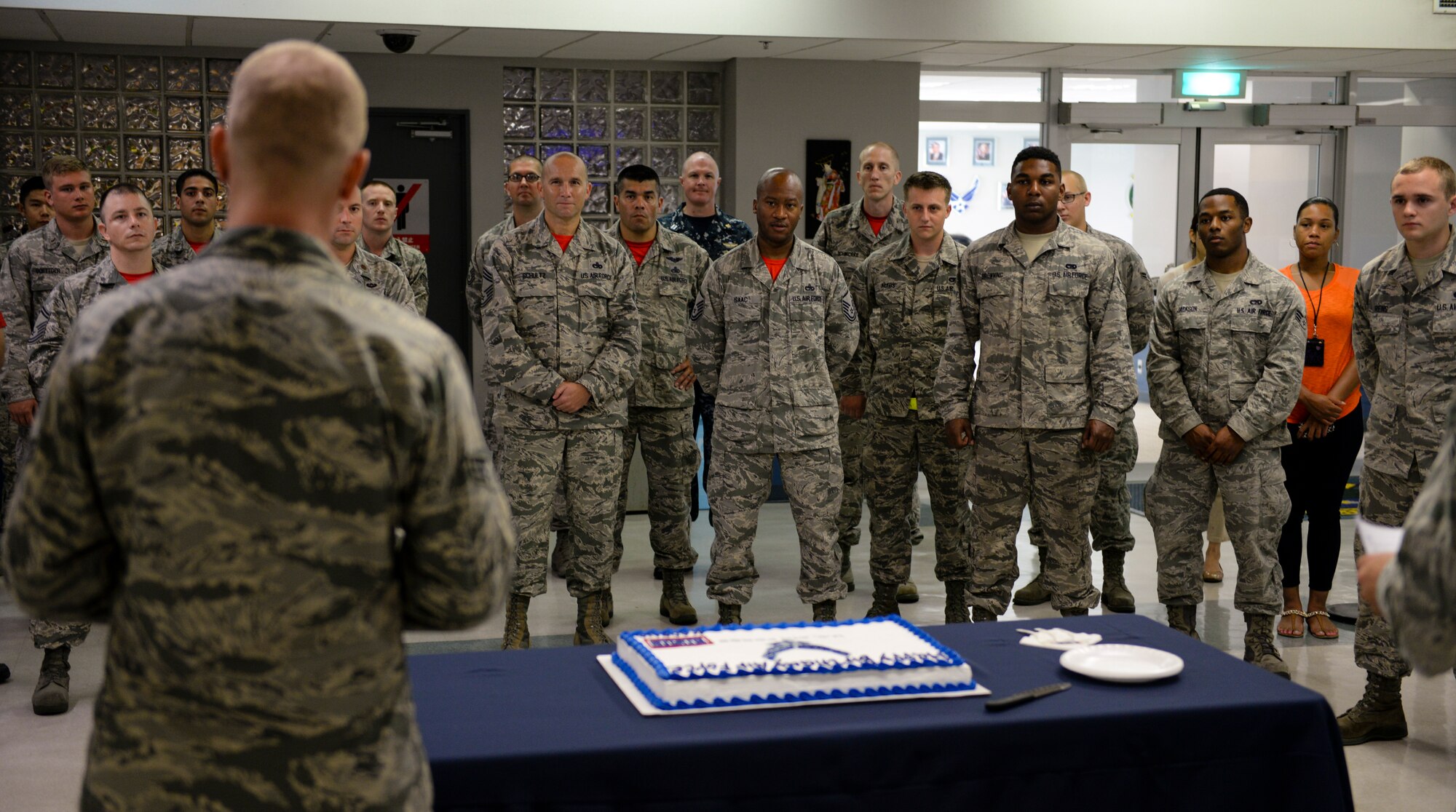 U.S. Air Force Senior Airman Jordan Boyd, 733rd Air Mobility Squadron passenger service agent, delivers a history lesson to observers of a cake cutting ceremony Sept. 18, 2015, at the Kadena Air Base Passenger Terminal, Japan. The event was held in celebration of the Air Force’s 68th Birthday. The Air Force first originated as an aeronautical division in the U.S. Army and has since grown to a branch of service that dominates the skies with unmatched airpower. (U.S. Air Force photo by Senior Airman John Linzmeier)