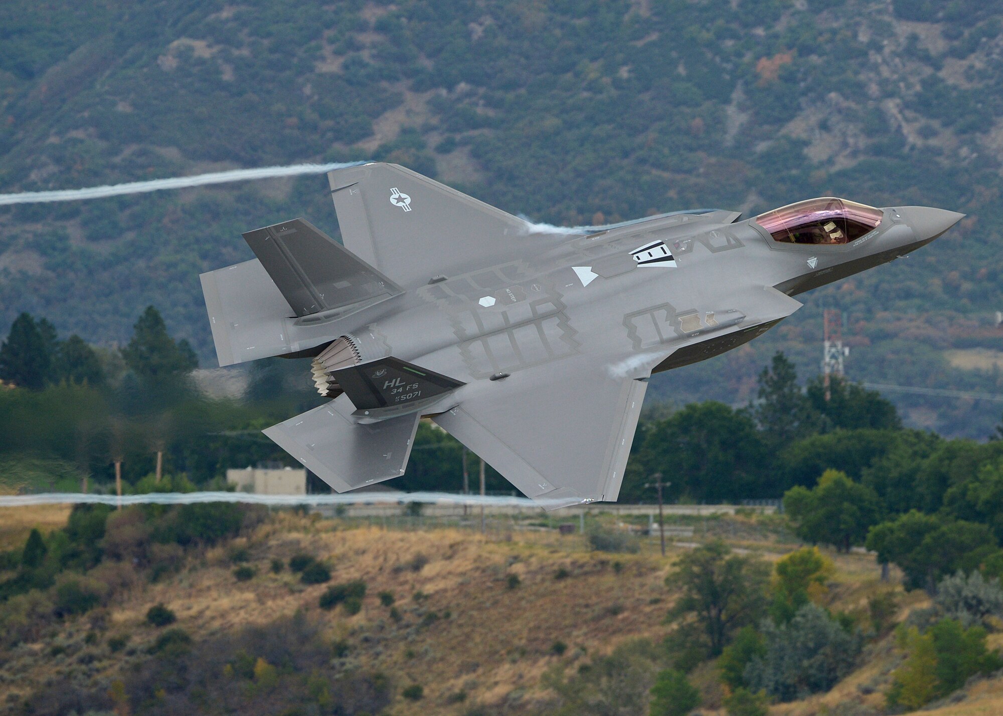 34th Fighter Squadron Commander Lt. Col. George Watkins flies a combat-coded F-35A Lightning II aircraft past the control tower at Hill Air Force Base, Utah, Sept. 17. During the sortie, the base’s first, Watkins conducted mission qualification training focusing on weapons employment, range familiarization and mission system proficiency.  (U.S. Air Force photo/Alex R. Lloyd)