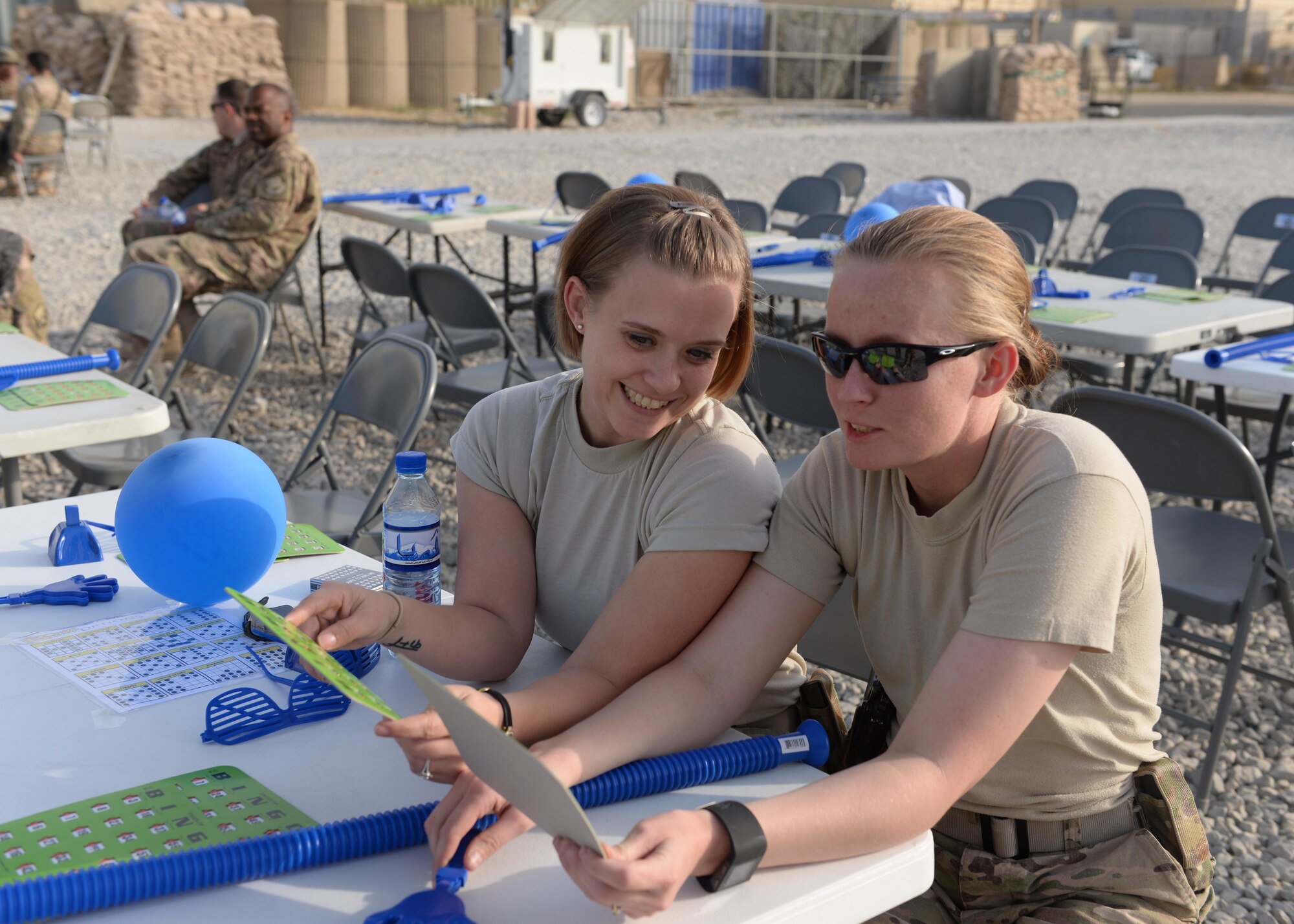 U.S. Air Force Master Sgt. Natasha Hoglund, left), and Staff Sgt. Angel Kozar, 455th Air Expeditionary Wing legal office, play a game of bingo during a block party held in honor of the Air Force’s 68th birthday Sept. 18, 2015, at Bagram Airfield, Afghanistan. The block party which was hosted by the Armed Forces Committed to Excellence council, the 455th Force Support Squadron and other private organizations featured games, food and a traditional AF cake cutting ceremony. (U.S. Air Force photo by Senior Airman Cierra Presentado/Released)