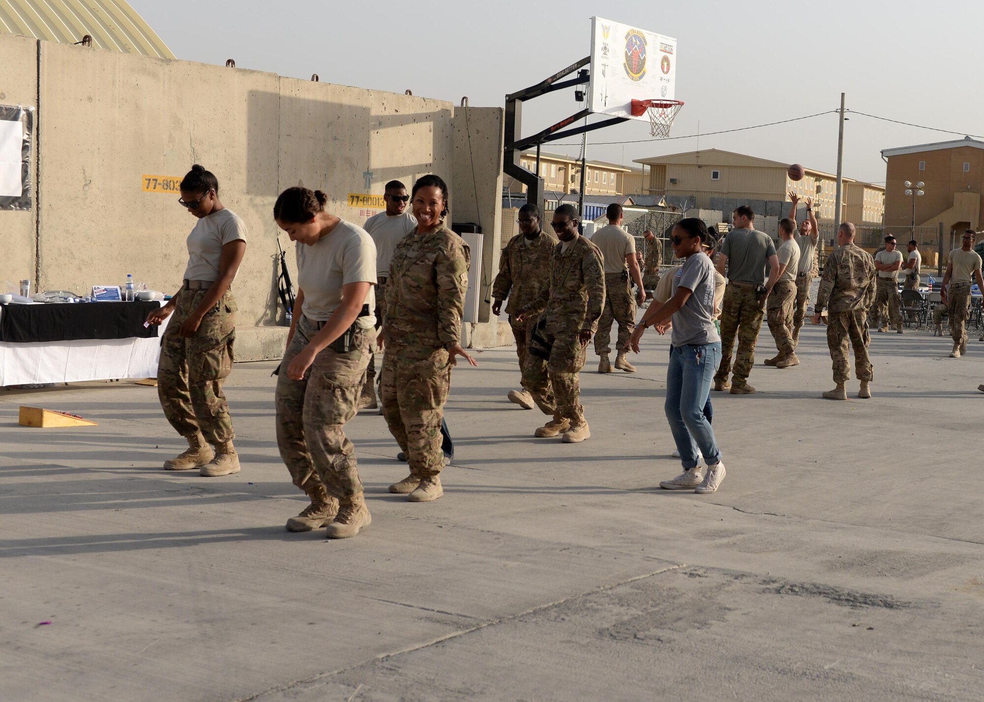 U.S. Airmen assigned to the 455th Air Expeditionary Wing dance to music during a block party held in honor of the Air Force’s 68th birthday Sept. 18, 2015, at Bagram Air Field, Afghanistan. The block party which was hosted by the Armed Forces Committed to Excellence council, the 455th Force Support Squadron and other private organizations featured games, food and a traditional AF cake cutting ceremony. (U.S. Air Force photo by Senior Airman Cierra Presentado/Released)