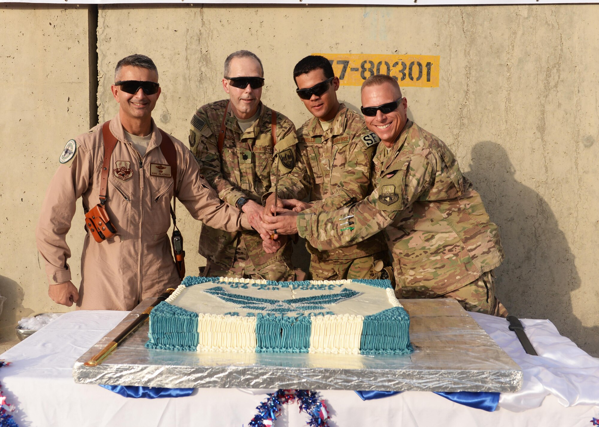 From left to right, U.S. Air Force Brig Gen. David Julazadeh, 455th Air Expeditionary Wing commander, Lt. Col. Ray Krueger 455th Expeditionary Medical Group chief of medicine, Airman 1st Class Wilmer Puello, 455 Expeditionary Security Forces Squadron FAST team member and Chief Master Sgt. Matthew Grengs, 455 AEW command chief cut a cake during the Air Force birthday celebration Sept. 18, 2014, at Bagram Airfield, Afghanistan. The cake cutting is an Air Force tradition in which the oldest and youngest Airmen cut the cake with the base commander and wing command chief. (U.S. Air Force photo by Senior Airman Cierra Presentado/Released)