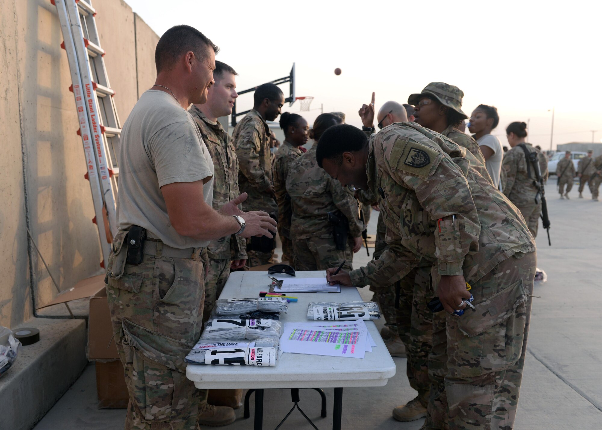 U.S. Airmen assigned to the 455th Air Expeditionary Wing sign up for the Air Force Marathon during an Air Force birthday celebration Sept. 18, 2015, at Bagram Airfield, Afghanistan. The block party which was hosted by the Armed Forces Committed to Excellence council, the 455th Force Support Squadron and other private organizations featured games, food and a traditional AF cake cutting ceremony. (U.S. Air Force photo by Senior Airman Cierra Presentado/Released)