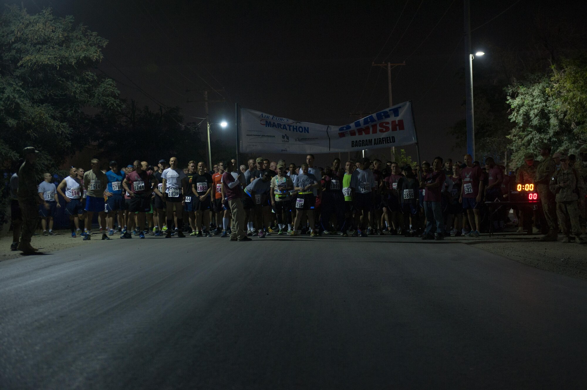 U.S. Service members, civilians and Coalition partners assigned to Bagram Airfield wait at the starting line for the beginning of the Air Force Marathon and Half Marathon at BAF, Afghanistan, Sept. 19, 2015. This year marked the 7th year that the AF has sanctioned deployed location races overseas. (U.S. Air Force photo by Tech. Sgt. Joseph Swafford/Released)
