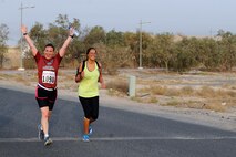 Senior Airman Racheal Watson, 386th Air Expeditionary Wing public affairs photojournalist, crosses the finish line of the Air Force Marathon 10K at a deployed location in Southwest Asia, Sept. 19, 2015. Watson has run the full Air Force Marathon, the half marathon and now the 10K race. (U.S. Air Force photo/Tech. Sgt. Brittany E. Jones)