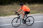 Army Lt. Col. Doug Owens, Army Medical Center Animal Health Brach chief, races down a hill of the 22-mile cycling portion of the annual Rambler 120 competition Sept. 19, 2015, at Joint Base San Antonio Recreation Park at Canyon Lake. The Rambler 120, which is hosted by the 502nd Force Support Squadron, features four- and eight-person teams that engage in a friendly, but hard-fought, competition that challenges participants with a 22-mile bike race, 6-mile run, 2-mile raft race and a mystery event.
