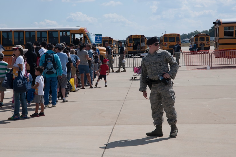 Senior Airman Andrew Rittenhouse, 11th Security Forces Squadron response force leader, performs crowd control during the 2015 Joint Base Andrews Air Show Sept. 19, 2015, on the flightline. Security forces kept order and assisted attendees during the show. (U.S. Air Force photo by Senior Airman Dylan Nuckolls/Released)
