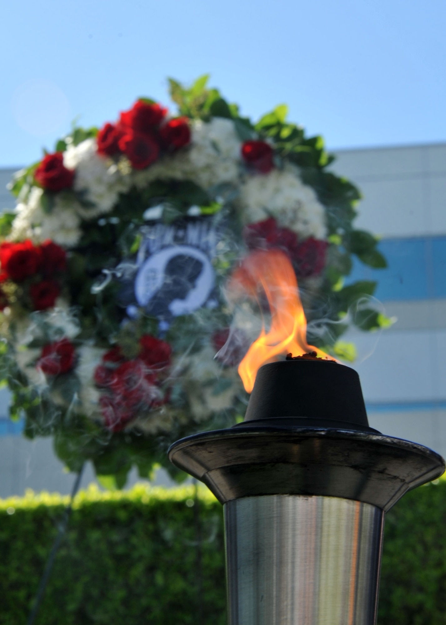 The POW/MIA wreath and torch lie in repose on the stage during the National POW/MIA Recognition Day ceremony Sept. 18 at the Space and Missile Systems Center's Schriever Space Complex at Los Angeles Air Force Base in El Segundo, Calif. (U.S. Air Force photo/Sarah Corrice)
