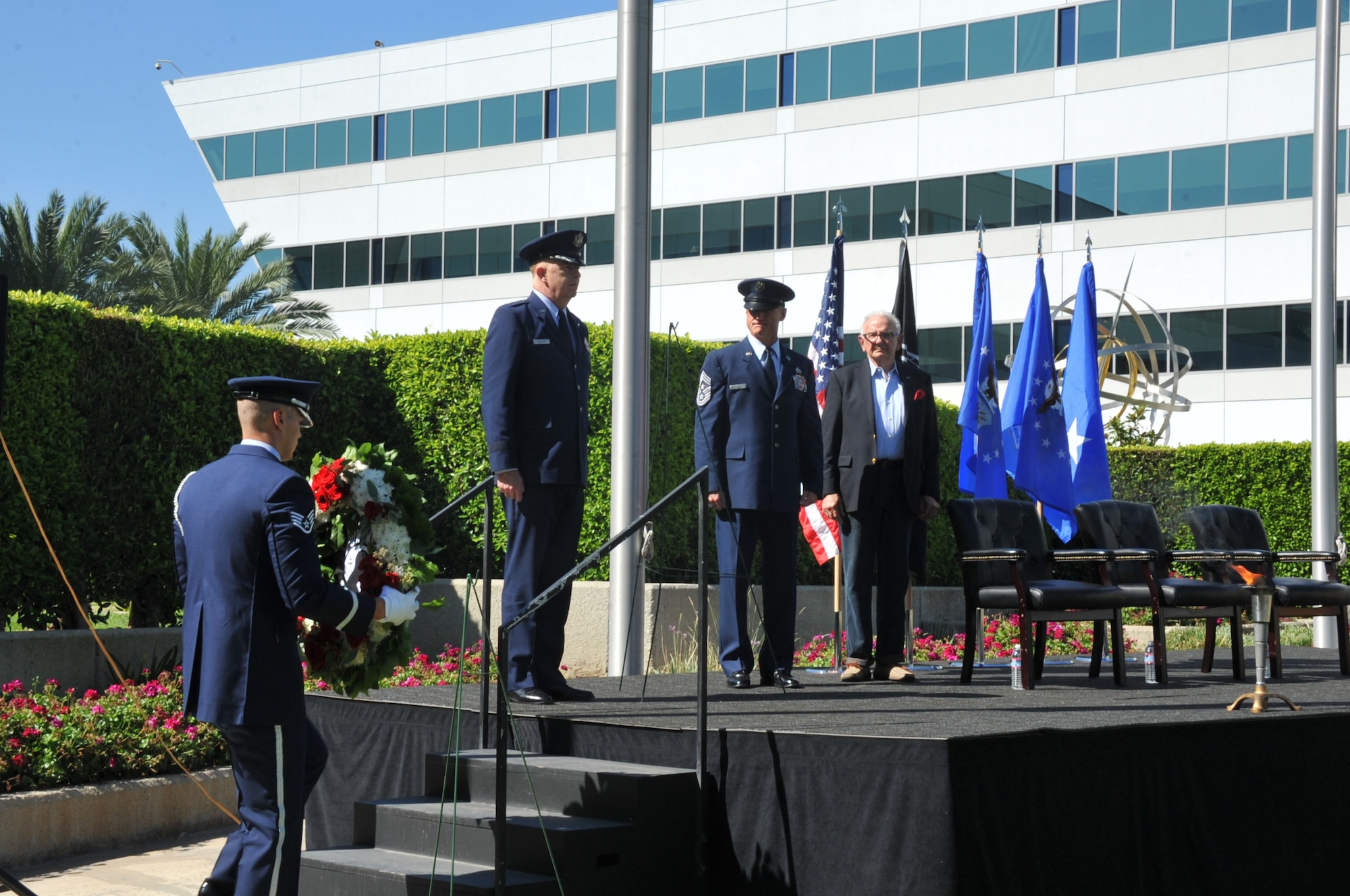 A member of the Air Force Honor Guard brings forward the POW/MIA wreath for placement on the stage during the National POW/MIA Recognition Day ceremony Sept. 18 at the Space and Missile Systems Center's Schriever Space Complex flagpole at Los Angeles Air Force Base in El Segundo, Calif. (U.S. Air Force photo/Sarah Corrice)