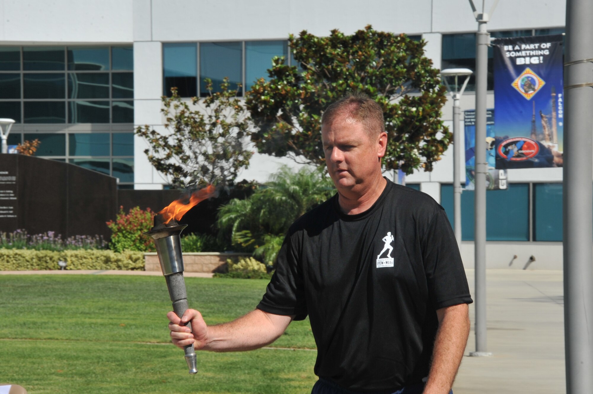 Col. Gerard Gleckel, Jr., deputy director of SMC’s Global Positioning Directorate, brings forward the POW/MIA torch to a position of honor on the stage during the National POW/MIA Recognition Day ceremony Sept. 18 at the Space and Missile Systems Center's Schriever Space Complex flagpole at Los Angeles Air Force Base in El Segundo, Calif. (U.S. Air Force photo/Sarah Corrice)