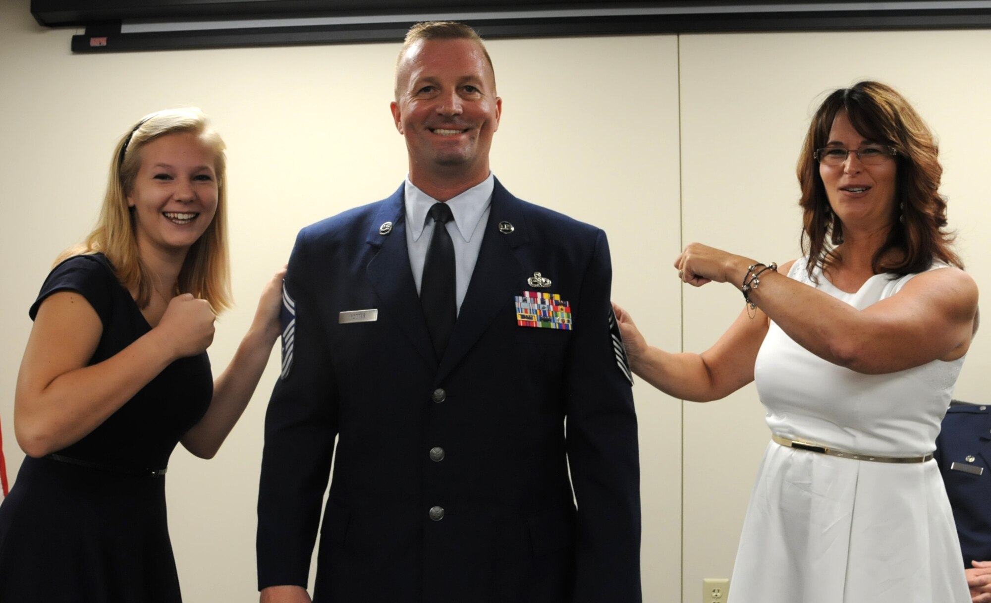 U.S. Air Force Chief Master Sgt. Harold Potter 927th Aircraft Maintenance Squadron superintendent, gets his new stripes tacked on by his wife Tricia, and his daughter Lexi at MacDill Air Force Base, FL on Sept. 19, 2015. During the ceremony, Potter recited the Chiefs Charge administered by Chief Master Sgt, Cameron Kirksey, Air Force Reserve command chief.